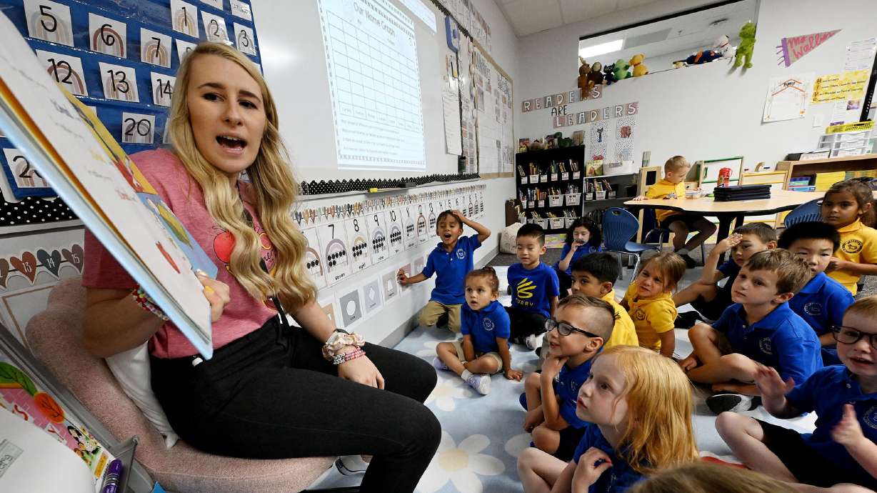 Teacher Kennedy Wallin reads to her kindergarten class during full-day kindergarten at Beehive Science and Technology Academy in Sandy on Friday. Data shows that students enrolled in full-day kindergarten are less likely to need academic interventions in later grades.