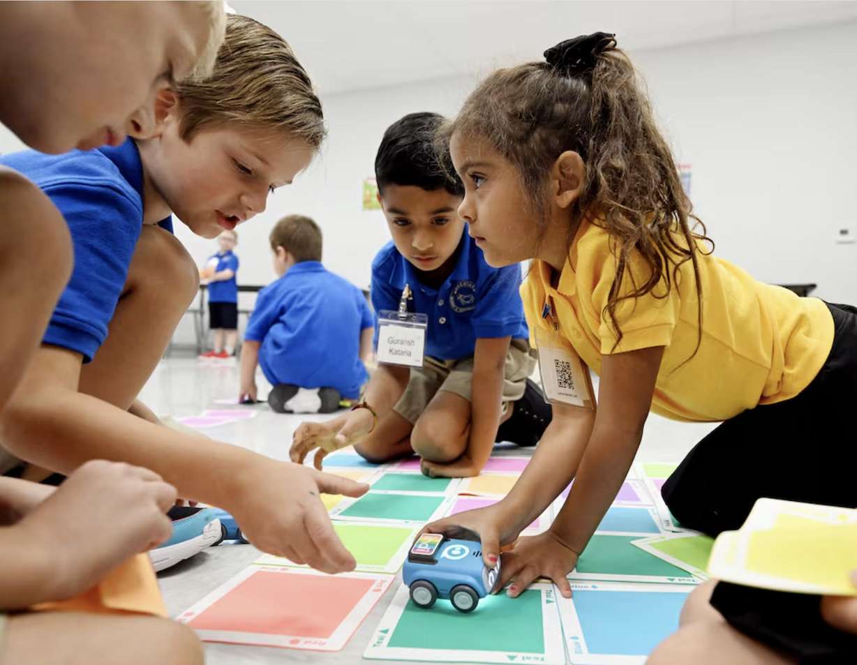 Elio Wilcox, Lukas Verostick, Guransh Kataria and Lavinia Leal work to figure out how to guide their car on a colored road during their full-day kindergarten at Beehive Science and Technology Academy in Sandy on Friday.