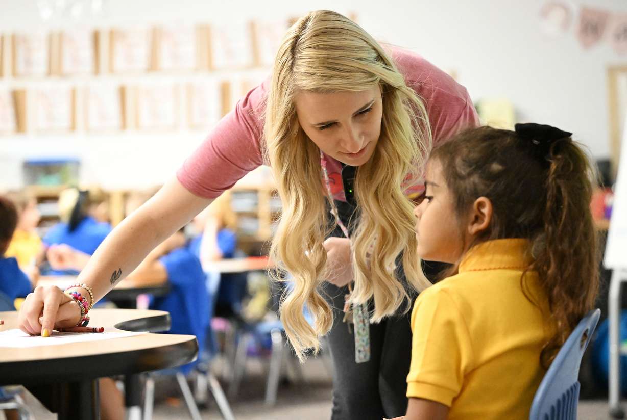 Teacher Kennedy Wallin helps Lavinia Leal with an assignment during her full-day kindergarten class at Beehive Science and Technology Academy in Sandy on Friday.