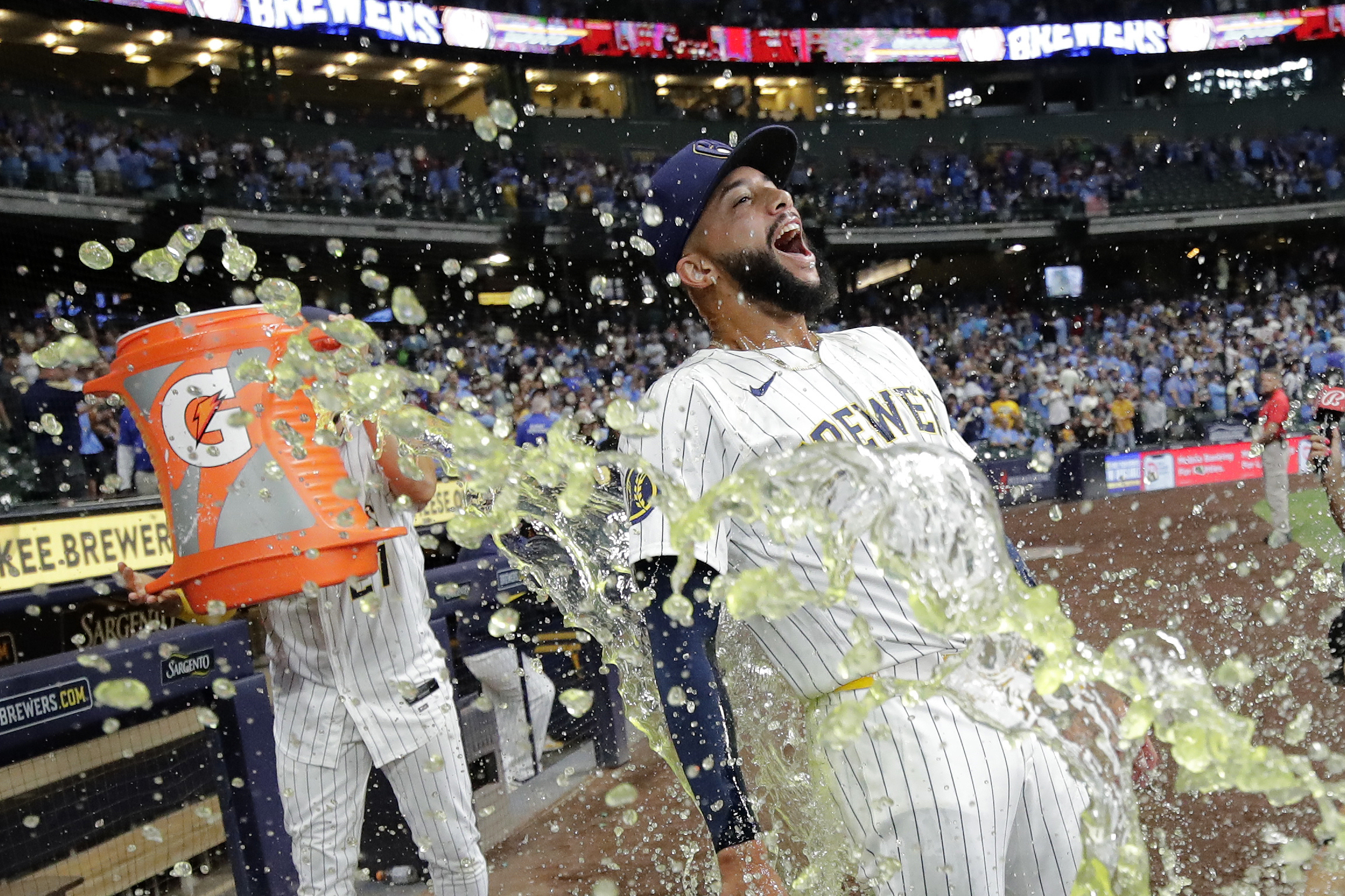 Milwaukee Brewers' Devin Williams, right, gets doused with liquid by Willy Adames after a baseball game against the Cincinnati Reds, Saturday, Aug. 10, 2024, in Milwaukee.