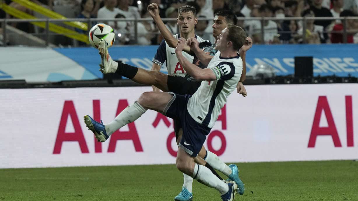 Bayern Munich's Adin Licina, center, fights for the ball with Tottenham Hotspur's Oliver Skipp, right, during a preseason soccer match at Seoul World Cup Stadium in Seoul, South Korea, Saturday, Aug. 3, 2024.