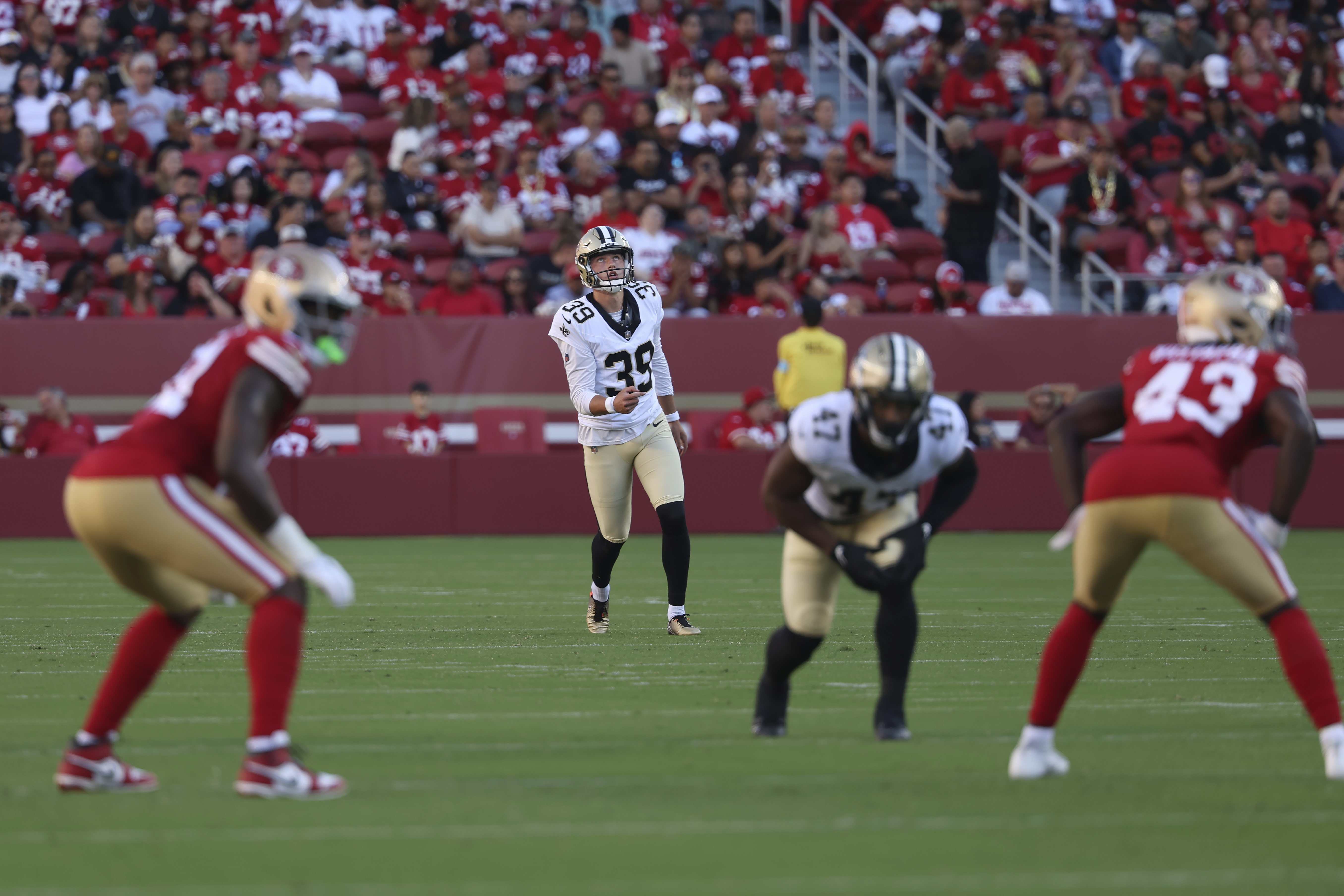 New Orleans Saints place kicker Charlie Smyth (39) watches his kickoff during the first half of a preseason NFL football game against the San Francisco 49ers in Santa Clara, Calif., Sunday, Aug. 18, 2024. 