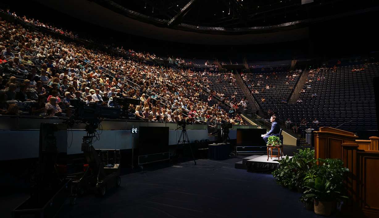Steve Young speaks during BYU Education Week at the Marriott Center in Provo on Monday.
