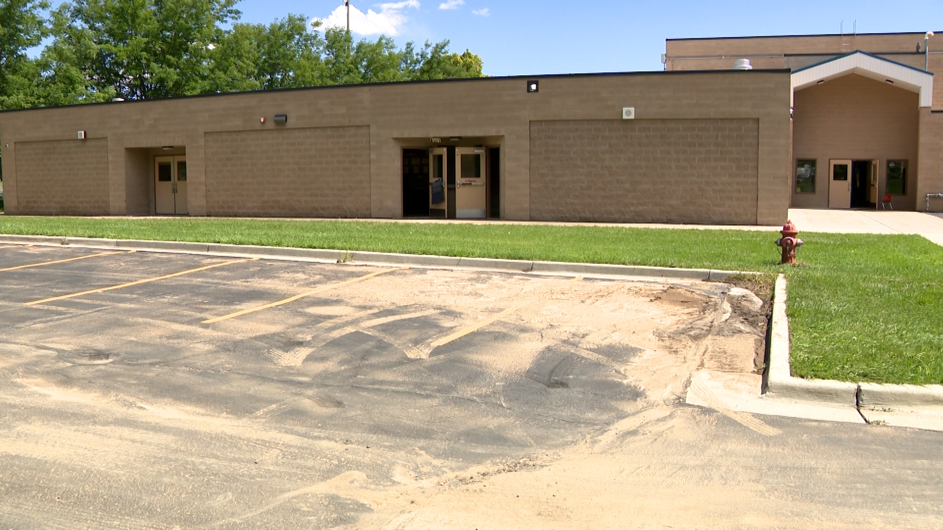 The Fountain Green Elementary School parking lot is seen Monday after a flood on Sunday.