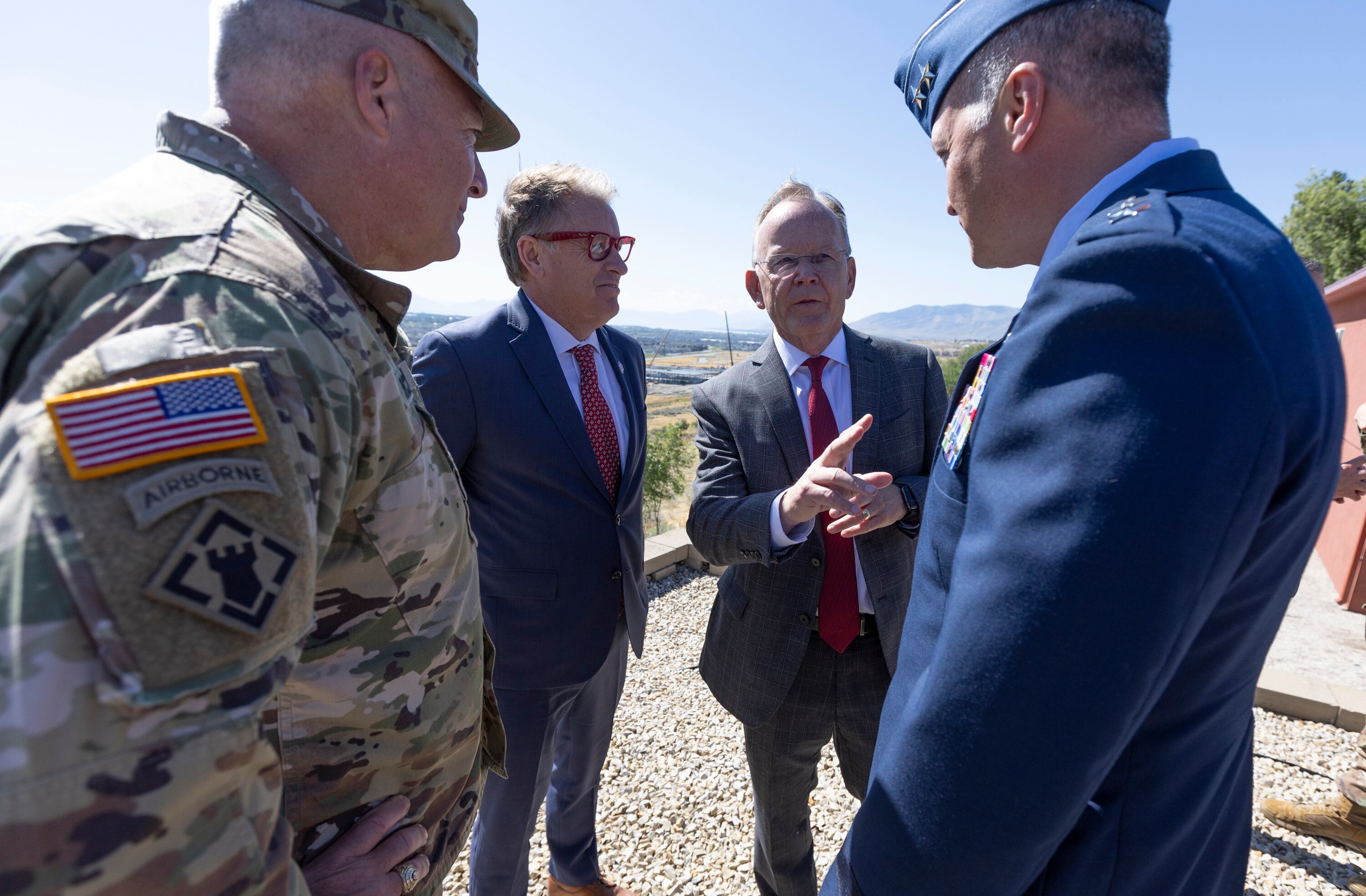 Commanding General of the 88th Readiness Division Maj. Gen. Joseph A. Ricciardi, left, University of Utah President Taylor Randall, center left, Utah Senate President J. Stuart Adams, center right, and Utah National Guard Brig. Gen. Daniel Boyack speak with each other at a groundbreaking ceremony celebrating a land transfer and relocation agreement between the University of Utah and the U.S. Army Reserve at Camp Williams in Bluffdale on Monday.