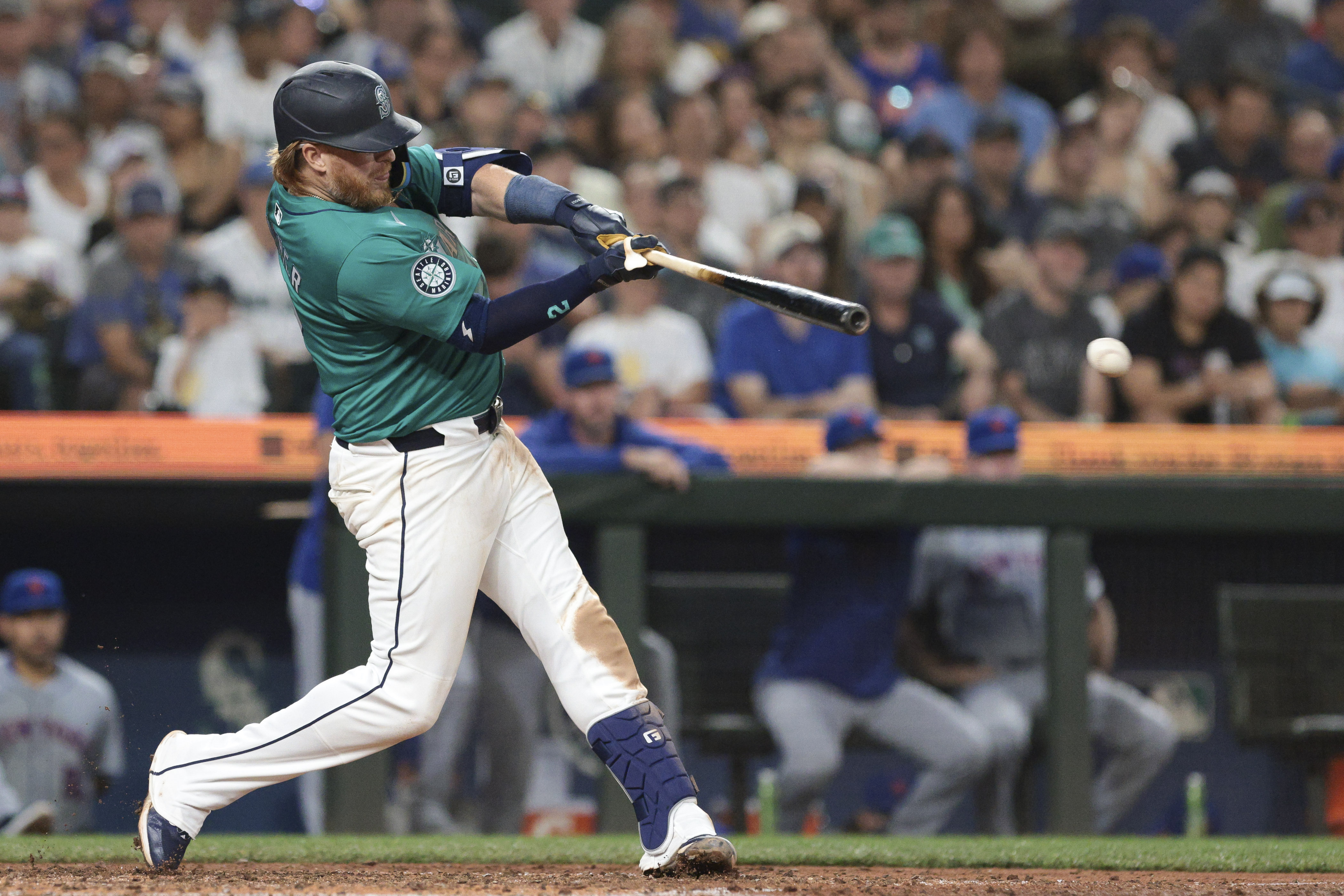 Seattle Mariners' Justin Turner follows through on an RBI single off a pitch by New York Mets pitcher Phil Maton during the seventh inning of a baseball game, Saturday, Aug. 10, 2024, in Seattle. 