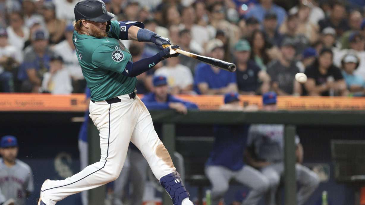 Seattle Mariners' Justin Turner follows through on an RBI single off a pitch by New York Mets pitcher Phil Maton during the seventh inning of a baseball game, Saturday, Aug. 10, 2024, in Seattle.