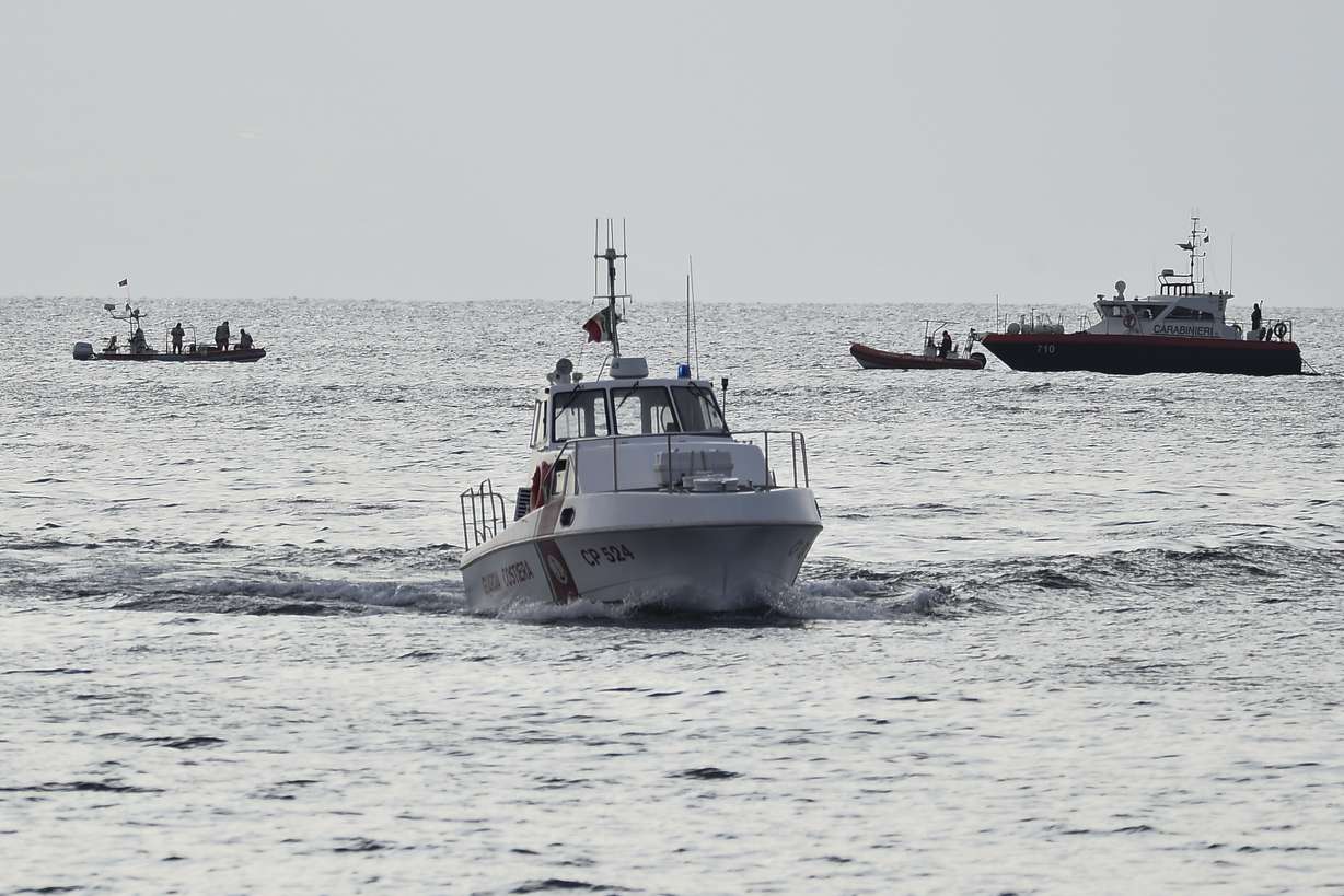 Emergency services at the scene of the search for a missing boat in Porticello, southern Italy, Tuesday.
