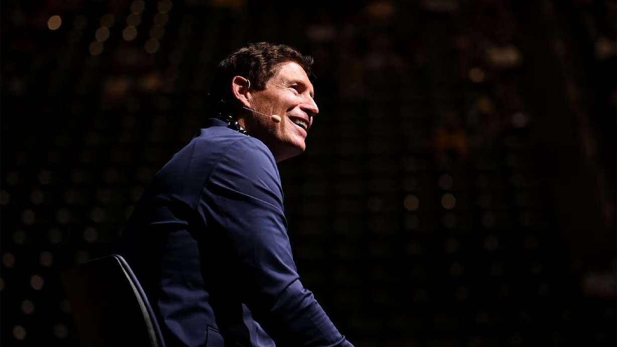 Steve Young speaks about taught him about love and competition during BYU Education Week at the Marriott Center in Provo on Monday.
