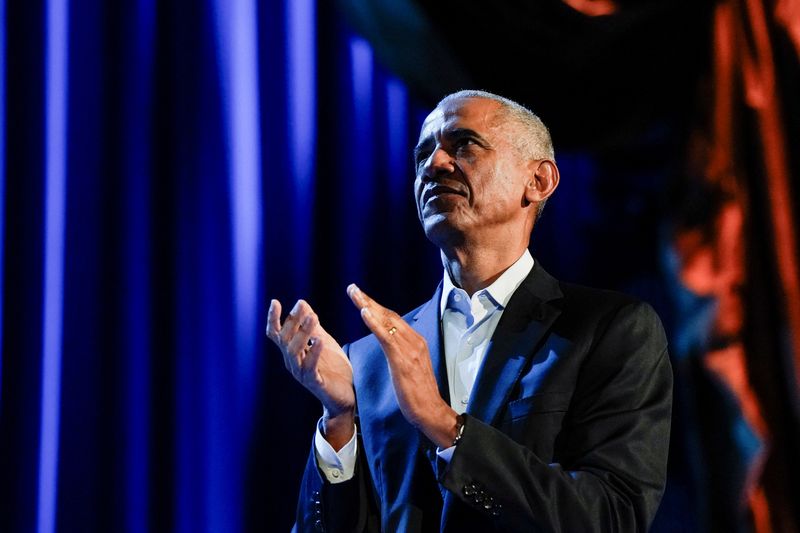 Former President Barack Obama applauds as he participates in a discussion moderated by Stephen Colbert, host of CBS's "The Late Show with Stephen Colbert," during a campaign fundraising event at Radio City Music Hall in New York, March 28.