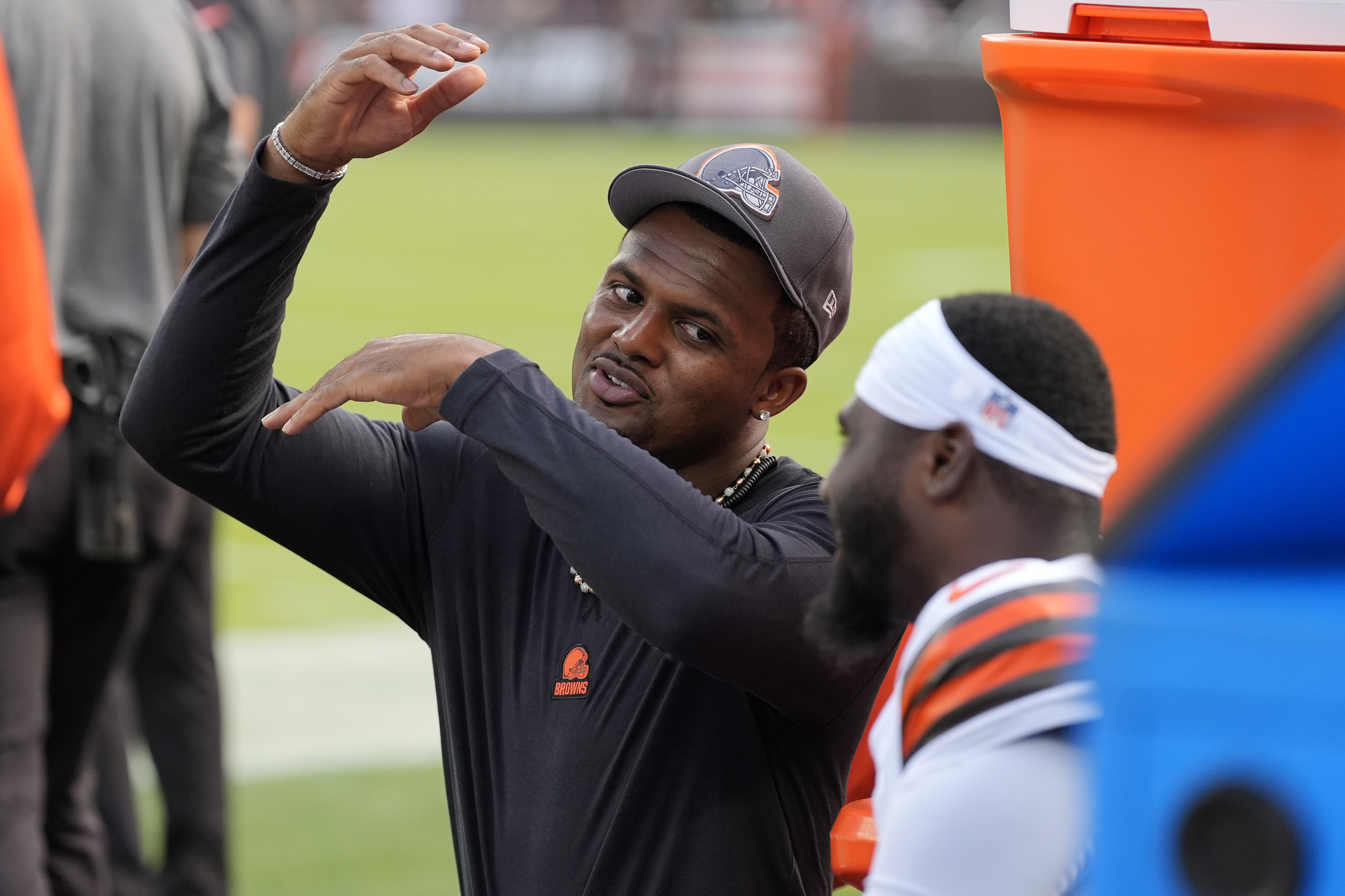 Cleveland Browns quarterback Deshaun Watson talks with teammates on the sidelines during the first half of an NFL preseason football game against the Minnesota Vikings, Saturday, Aug. 17, 2024, in Cleveland. 