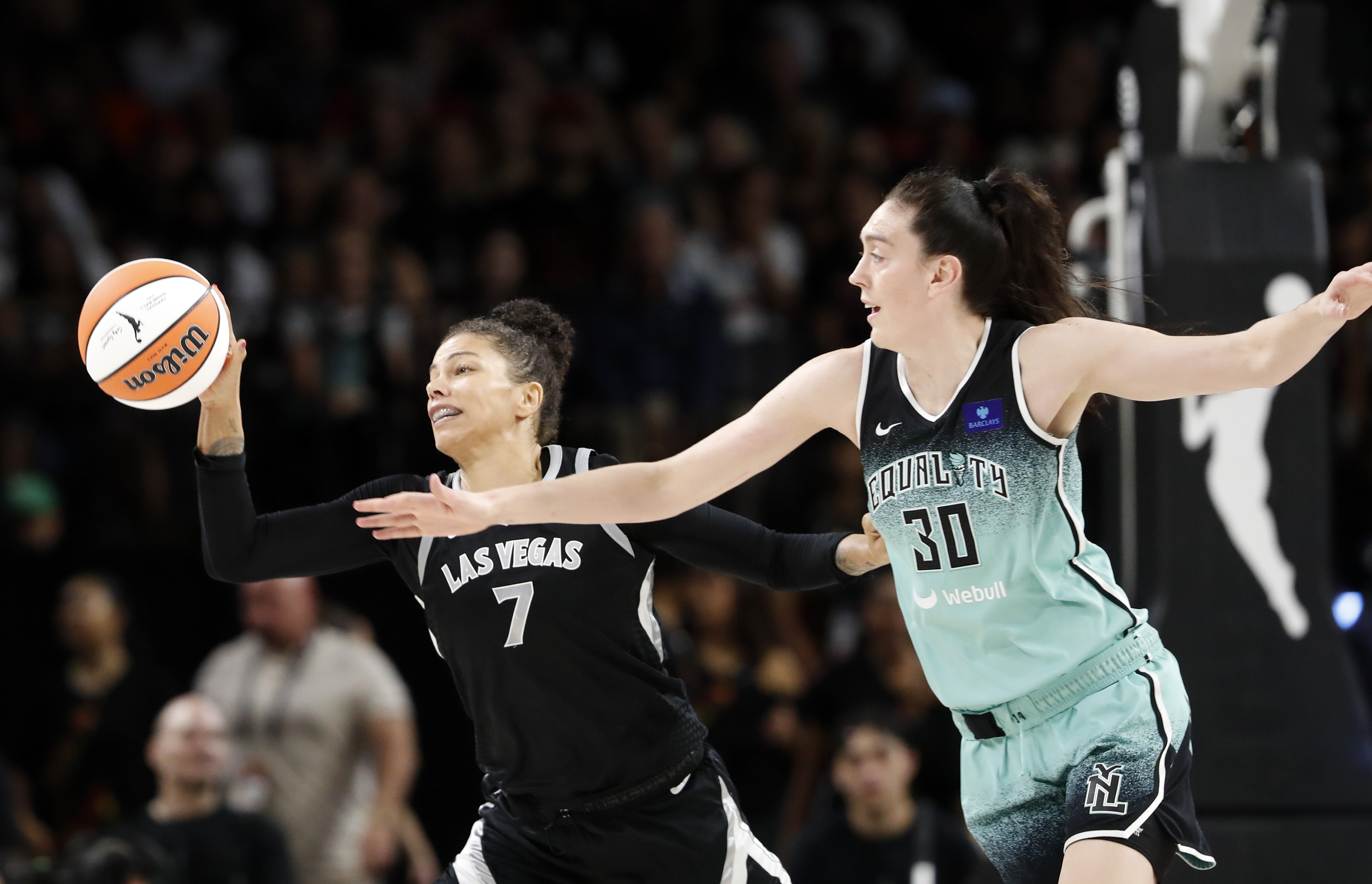 Las Vegas Aces forward Alysha Clark (7) picks off a pass intended for New York Liberty forward Breanna Stewart (30) during the first half of a WNBA basketball game Saturday, Aug. 17, 2024, in Las Vegas. 