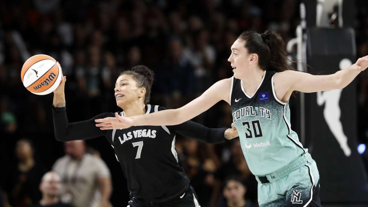 Las Vegas Aces forward Alysha Clark (7) picks off a pass intended for New York Liberty forward Breanna Stewart (30) during the first half of a WNBA basketball game Saturday, Aug. 17, 2024, in Las Vegas.