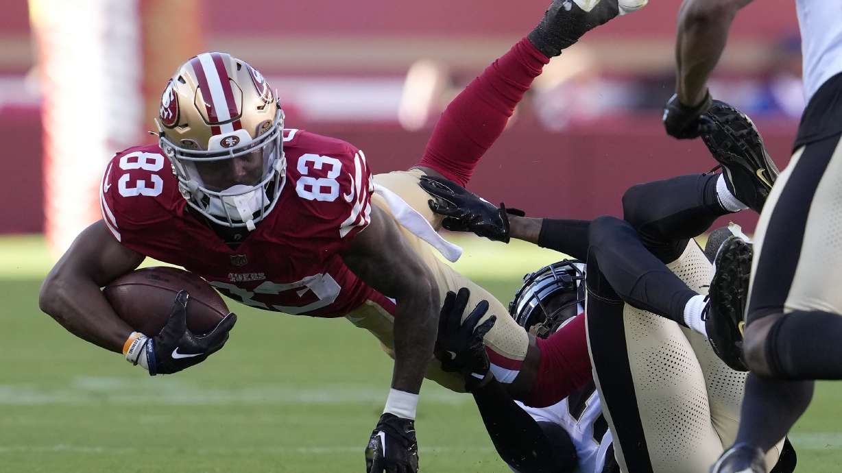 San Francisco 49ers wide receiver Jacob Cowing (83) is tackled by New Orleans Saints cornerback Rejzohn Wright during the first half of a preseason NFL football game in Santa Clara, Calif., Sunday, Aug. 18, 2024.