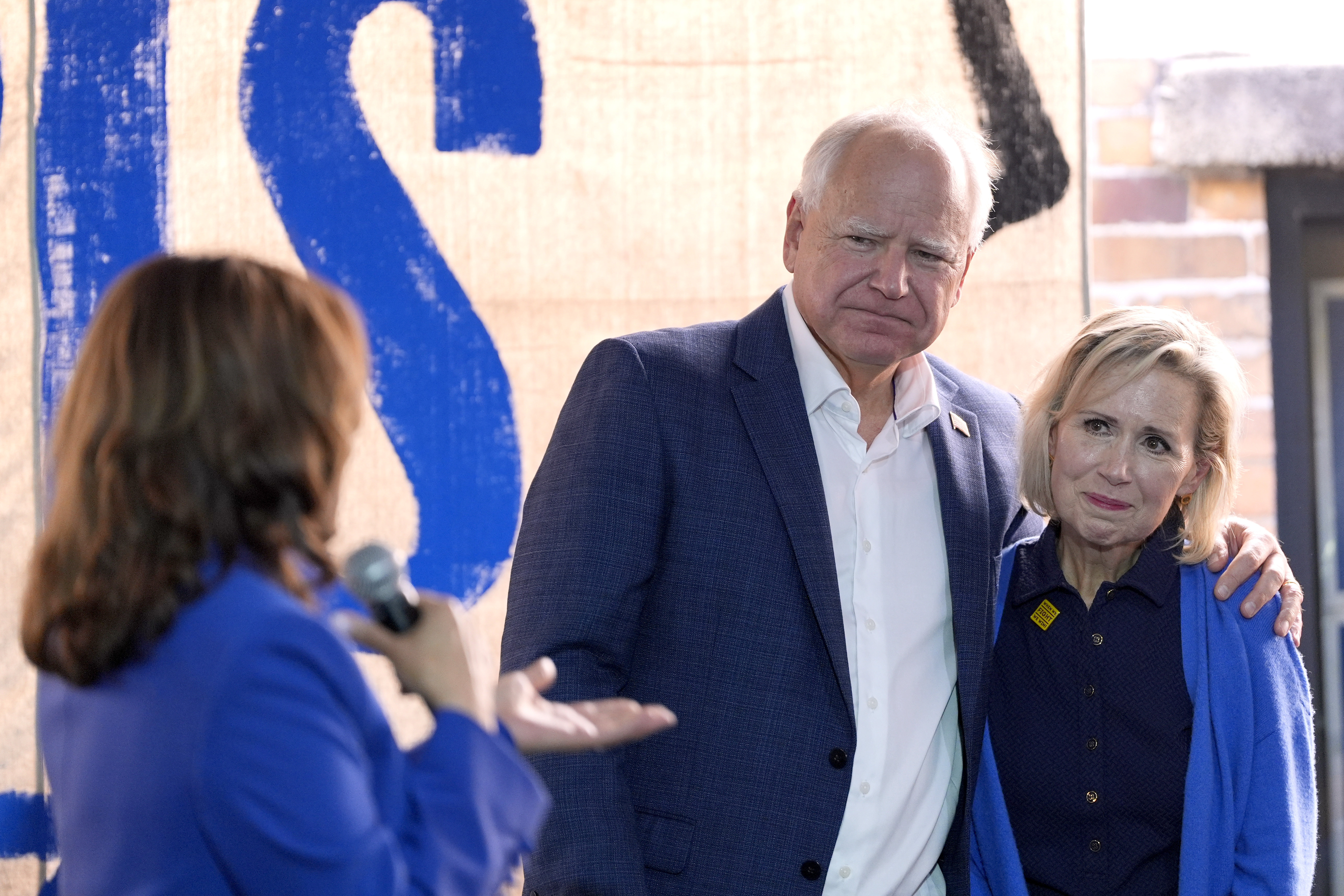 Vice President Kamala Harris, from left, addresses running mate Minnesota Gov. Tim Walz and his wife Gwen Walz at a campaign event, Sunday in Rochester, Pa. Walz is facing scrutiny for how he's described his family's struggle with infertility.