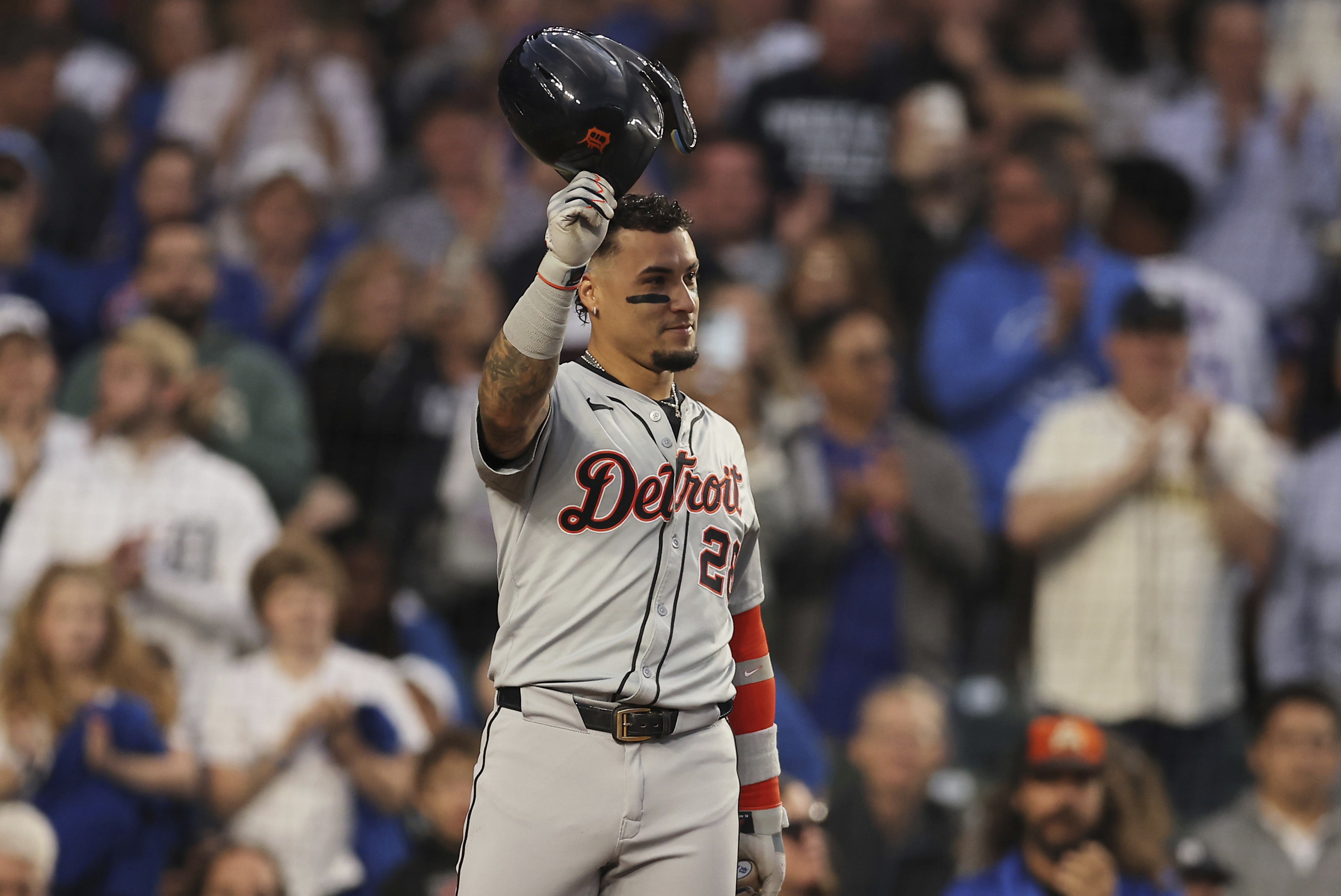 Detroit Tigers' Javier Báez raises his helmet to the fans on his first game back at Wrigley Field during the second inning to a baseball game against the Chicago Cubs Tuesday, Aug. 20, 2024, in Chicago. 