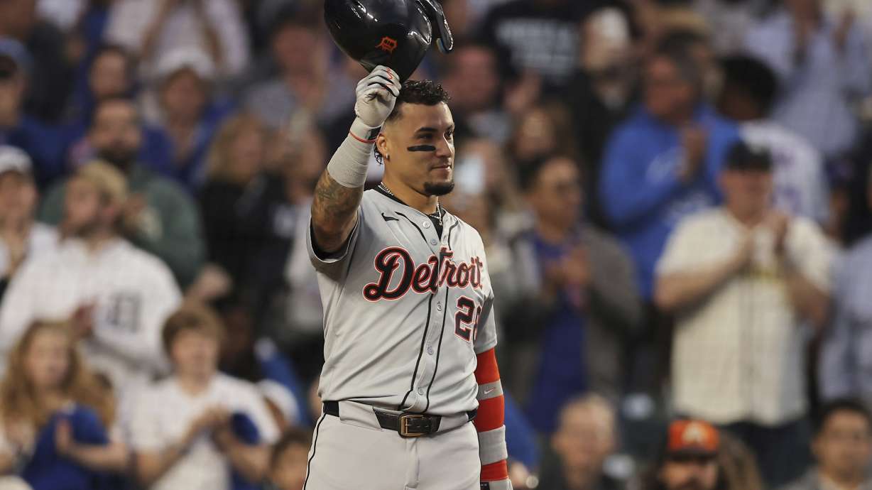 Detroit Tigers' Javier Báez raises his helmet to the fans on his first game back at Wrigley Field during the second inning to a baseball game against the Chicago Cubs Tuesday, Aug. 20, 2024, in Chicago.