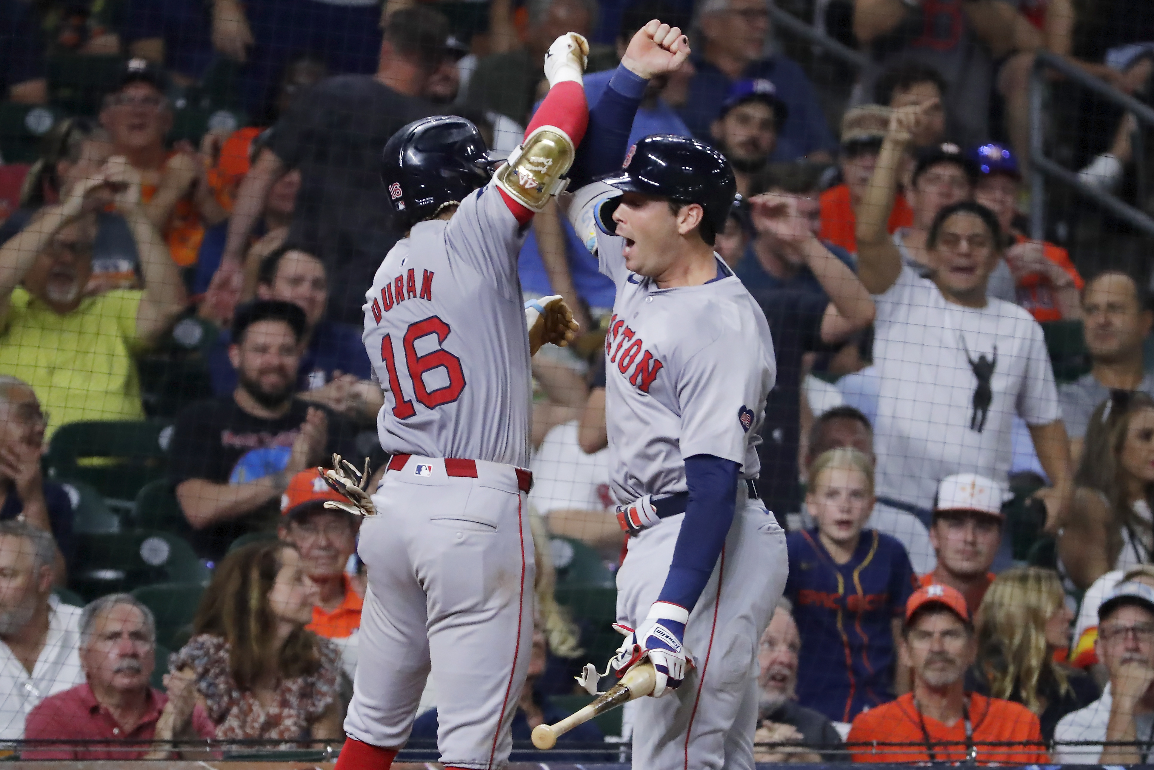 Boston Red Sox' Jarren Duran (16) and Triston Casas, right, celebrate the solo home run by Duran against the Houston Astros during the eighth inning of a baseball game Tuesday, Aug. 20, 2024, in Houston. 