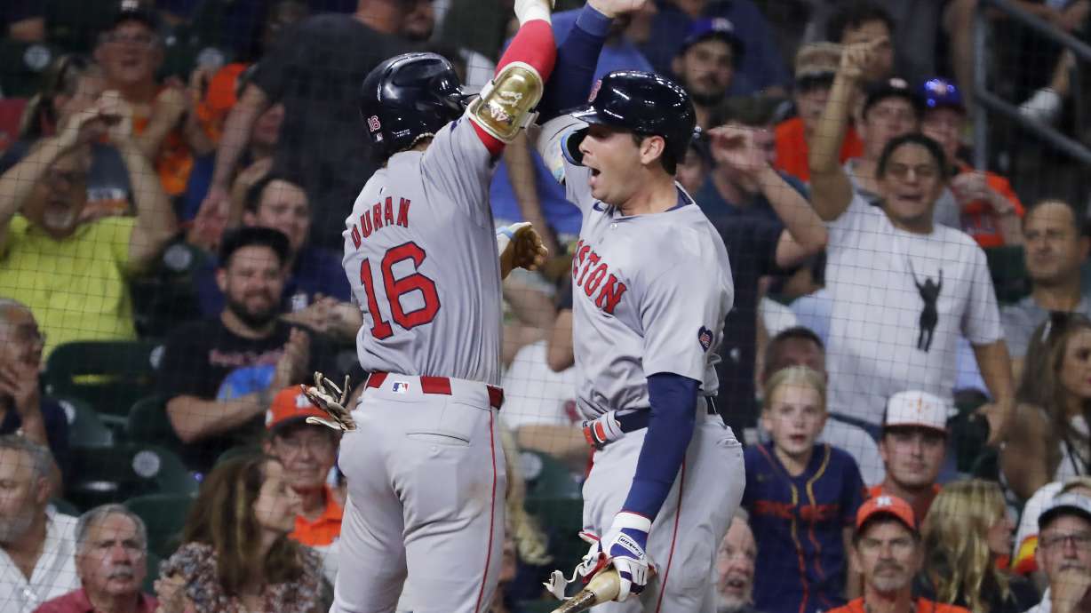 Boston Red Sox' Jarren Duran (16) and Triston Casas, right, celebrate the solo home run by Duran against the Houston Astros during the eighth inning of a baseball game Tuesday, Aug. 20, 2024, in Houston.