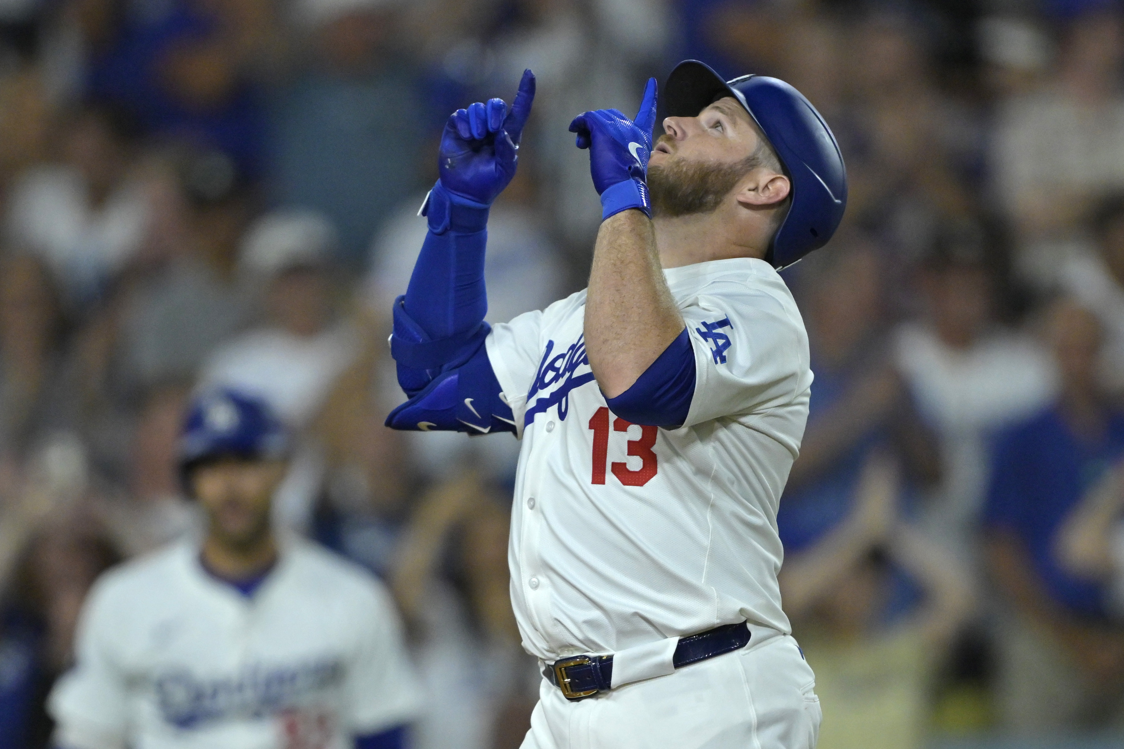 Los Angeles Dodgers' Max Muncy crosses the plate after hitting a solo home run in the fourth inning of a baseball game against the Seattle Mariners, Tuesday, Aug. 20, 2024, in Los Angeles. 