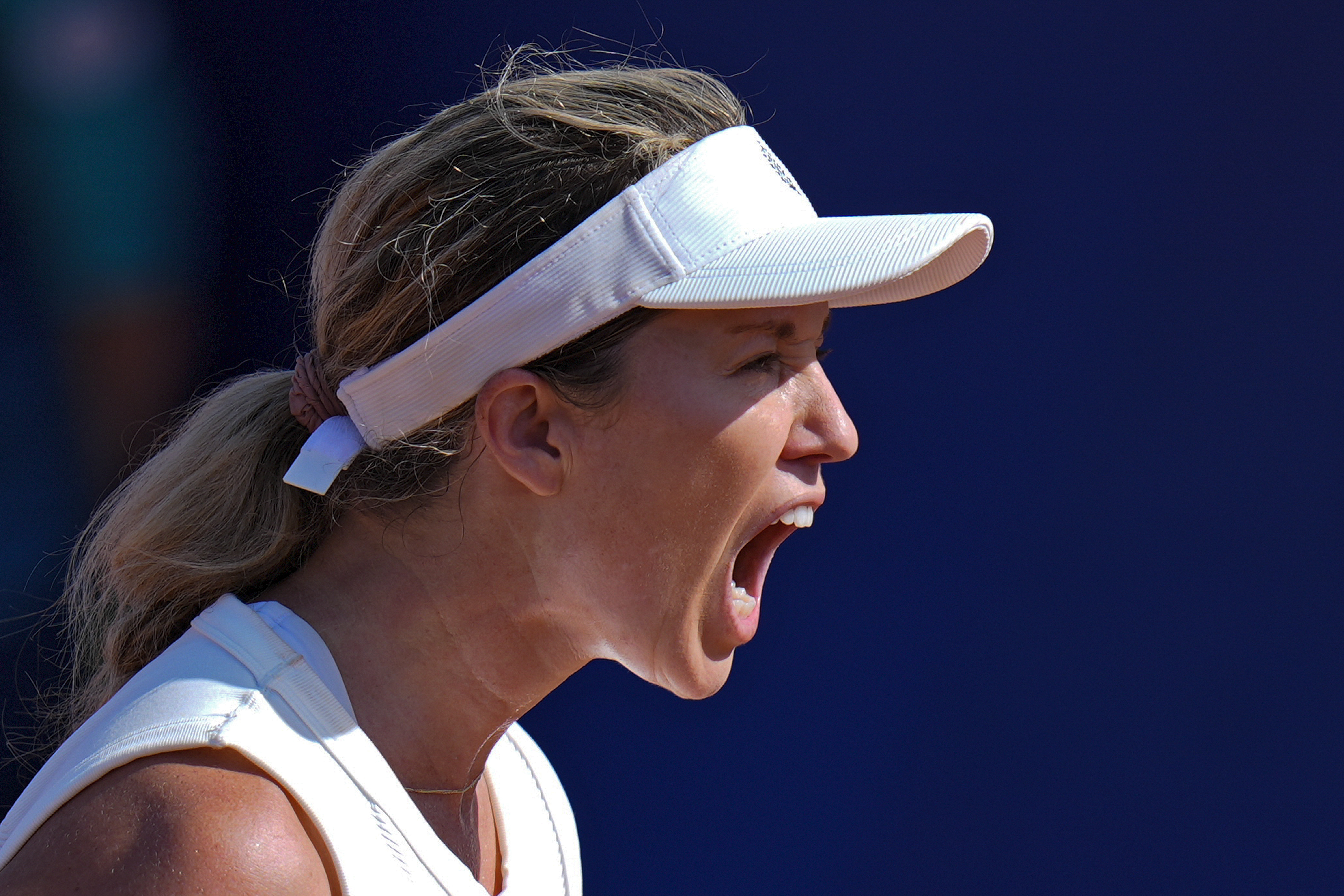 Danielle Collins of the United States reacts after scoring a point against Caroline Wozniacki of Denmark during their women's singles match at the Roland Garros stadium, at the 2024 Summer Olympics, Monday, July 29, 2024, in Paris, France.