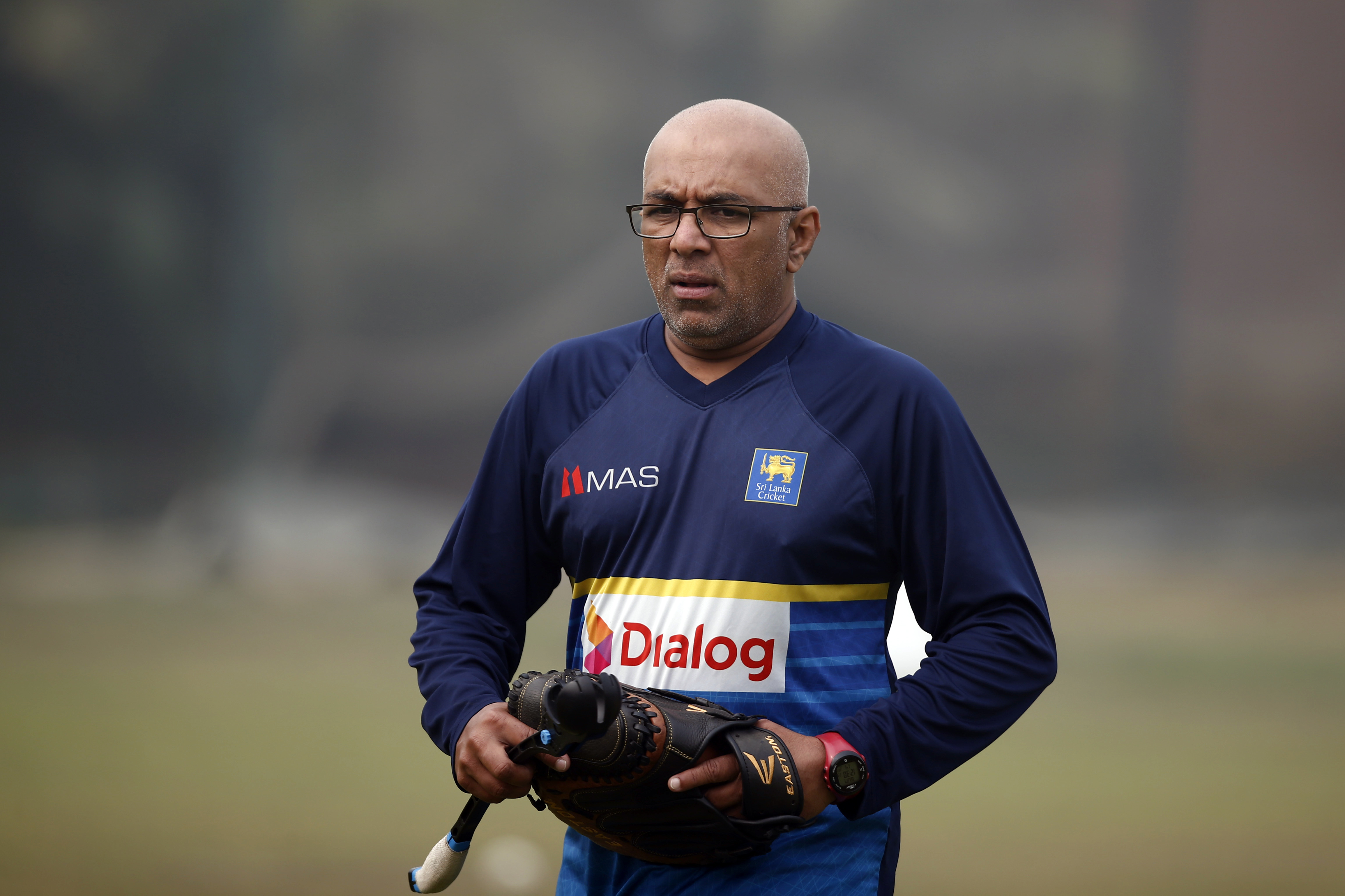 FILE - Sri Lanka's head coach Chandika Hathurusingha walks on the field during a training session ahead of the Tri-Nation one-day international cricket series in Dhaka, Bangladesh, Sunday, Jan. 14, 2018. Bangladesh head coach Chandika Hathurusingha is still interested in completing his contract with the men’s national cricket team to 2025 despite the recent political turmoil in the country. Bangladesh starts its first test against Pakistan in Rawalpindi on Wednesday, Aug. 21, 2024. 