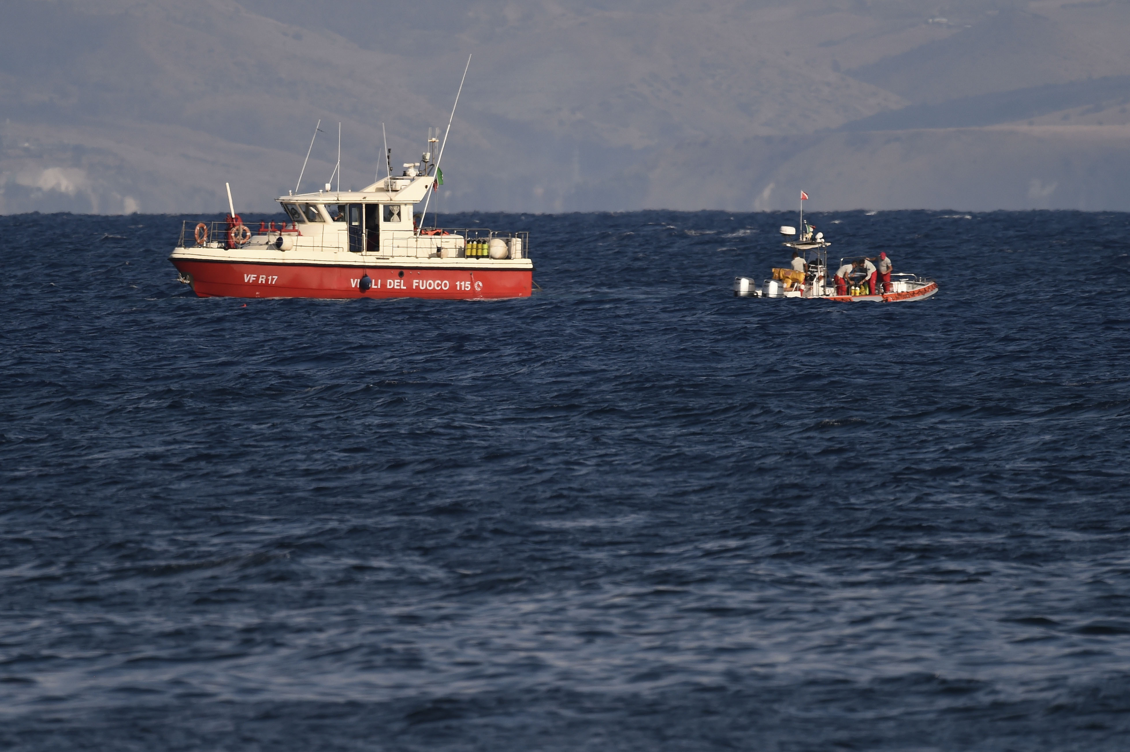 Emergency services at the scene of the search for a missing superyacht that sank, in Porticello, southern Italy, Tuesday. Divers have recovered five bodies as of Wednesday.