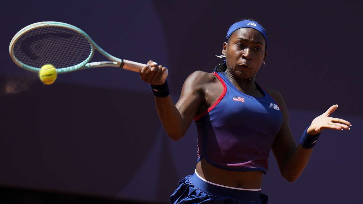 Coco Gauff of United States returns a shot to Donna Vekic of Croatiathe during their women's singles third round match at the Roland Garros stadium, at the 2024 Summer Olympics, Tuesday, July 30, 2024, in Paris, France.