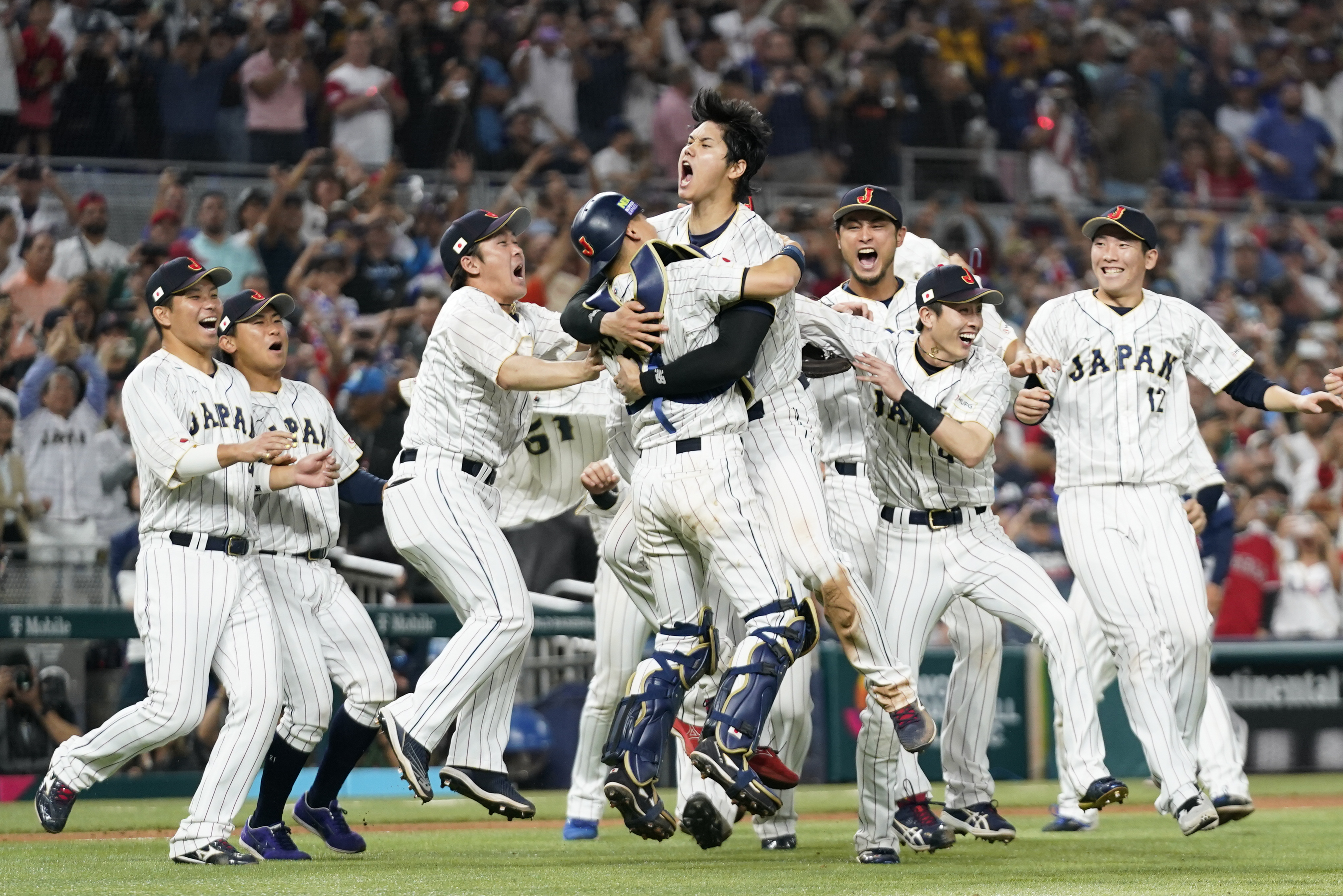 FILE - Japan player Shohei Ohtani (16) celebrates with his teammates after defeating the United States in the World Baseball Classic championship game, Tuesday, March 21, 2023, in Miami. 