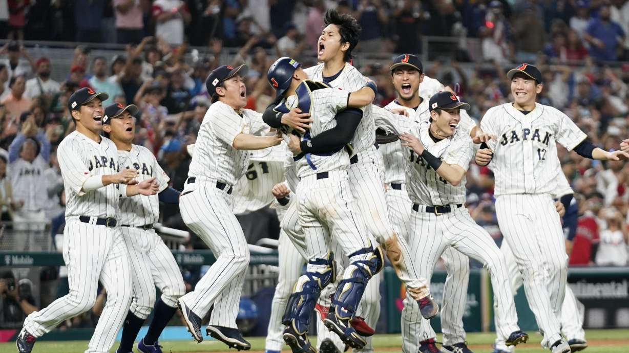 FILE - Japan player Shohei Ohtani (16) celebrates with his teammates after defeating the United States in the World Baseball Classic championship game, Tuesday, March 21, 2023, in Miami.