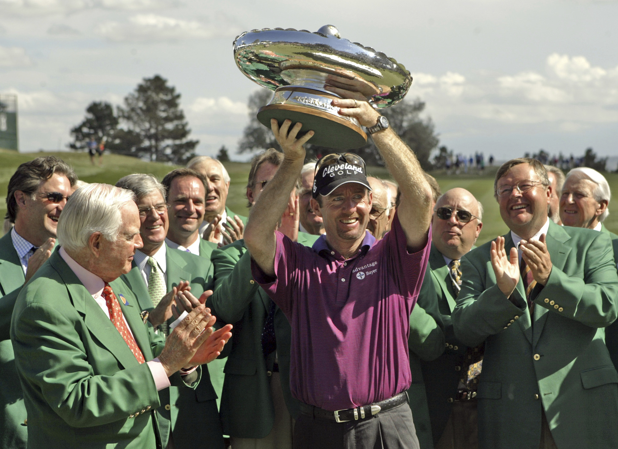 FILE - Jack Vickers, left, and other committee members look on as Australia's Rob Pampling holds the trophy after winning the International at Castle Pines in Castle Rock, Colo., Sunday, Aug. 8, 2004. 