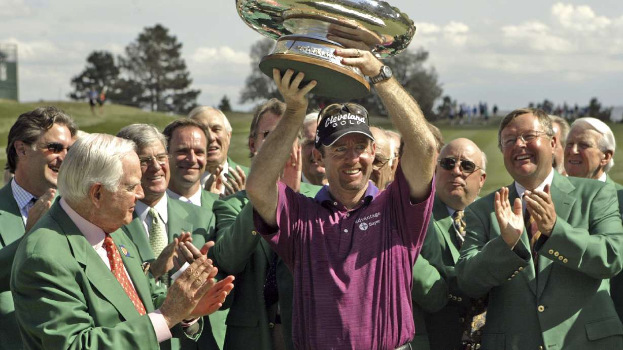 FILE - Jack Vickers, left, and other committee members look on as Australia's Rob Pampling holds the trophy after winning the International at Castle Pines in Castle Rock, Colo., Sunday, Aug. 8, 2004.