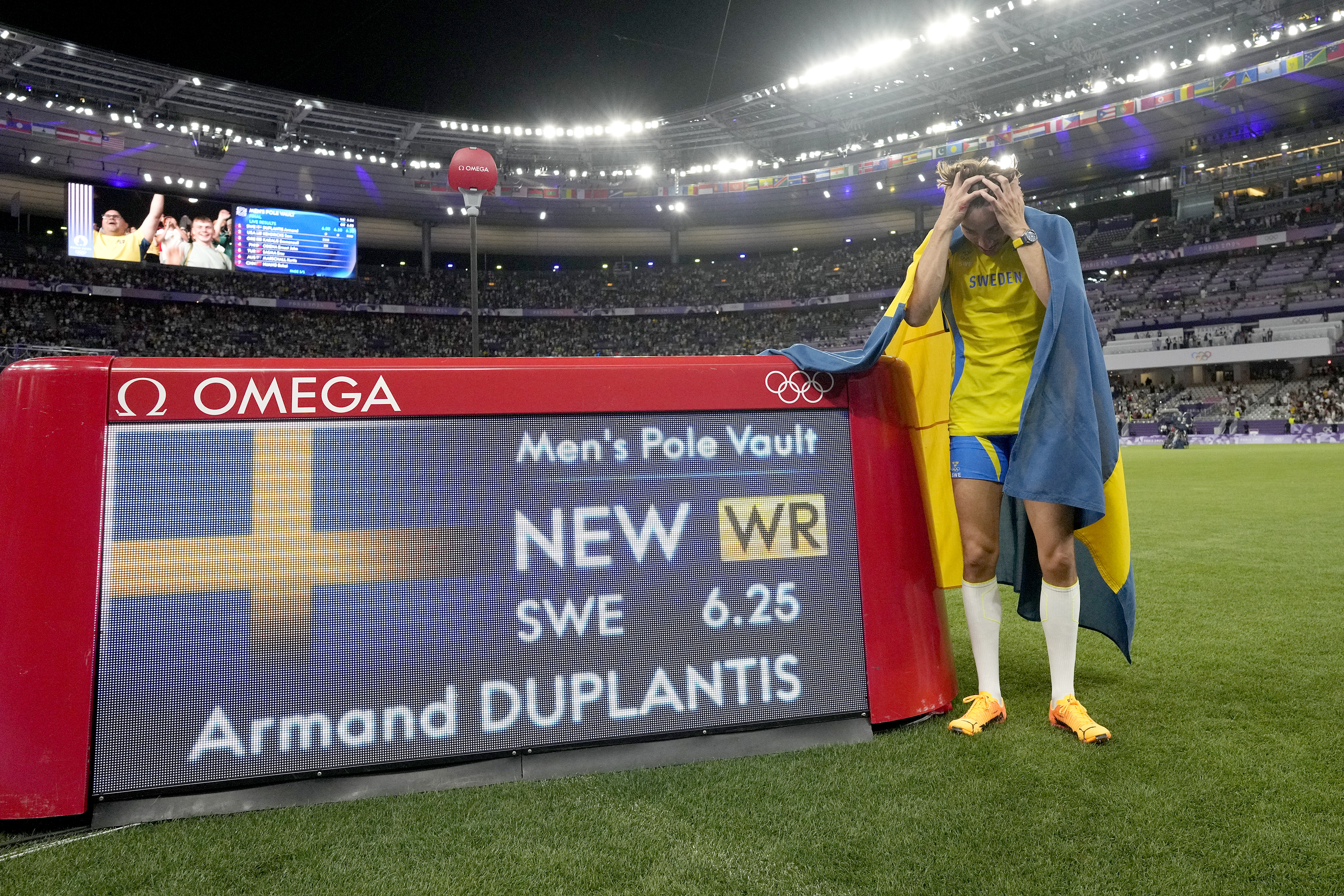 Armand Duplantis, of Sweden, reacts after setting a new world record in the men's pole vault final at the 2024 Summer Olympics, Monday, Aug. 5, 2024, in Saint-Denis, France.