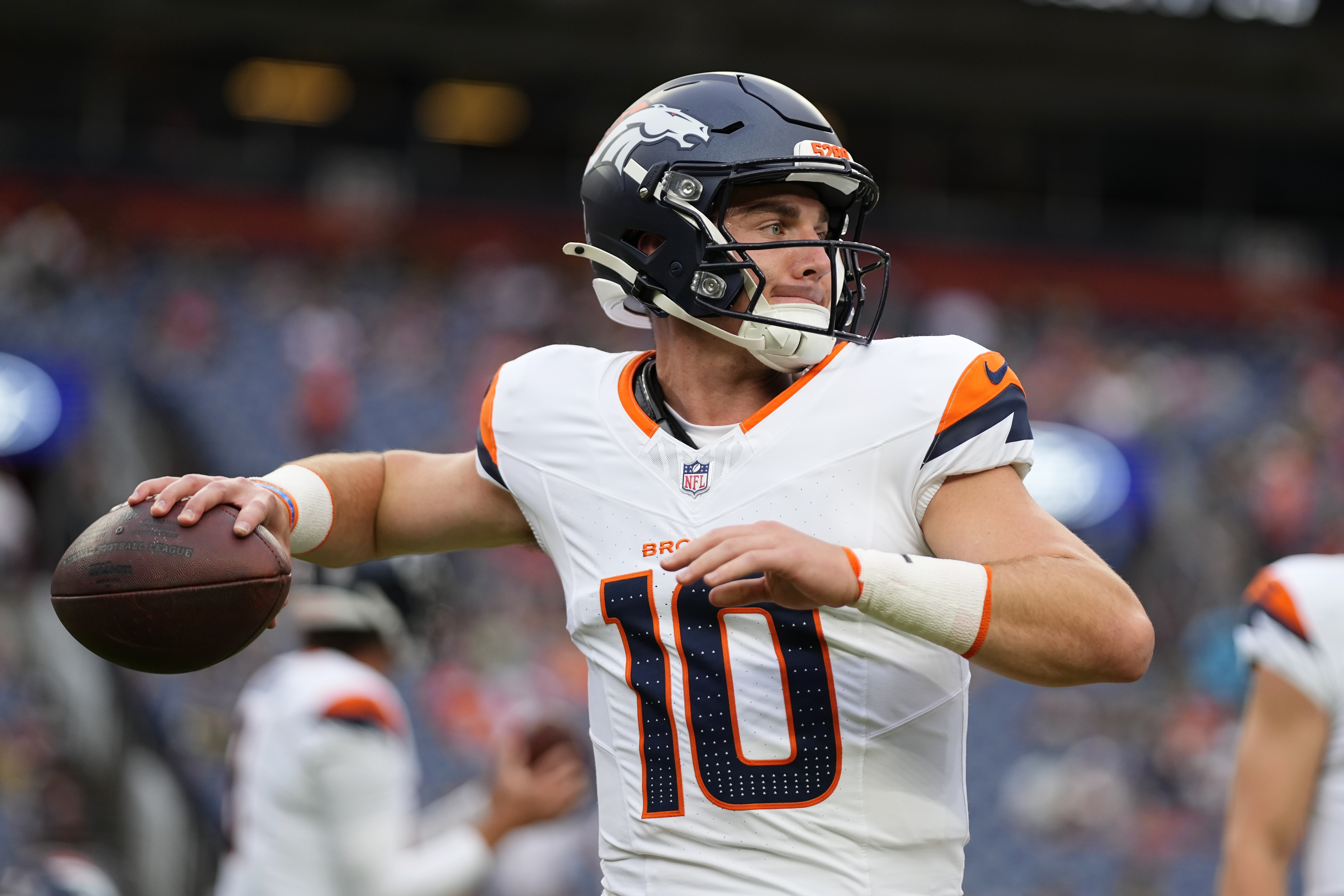 Denver Broncos quarterback Bo Nix warms up before a preseason NFL football game against the Green Bay Packers, Sunday, Aug. 18, 2024, in Denver. 
