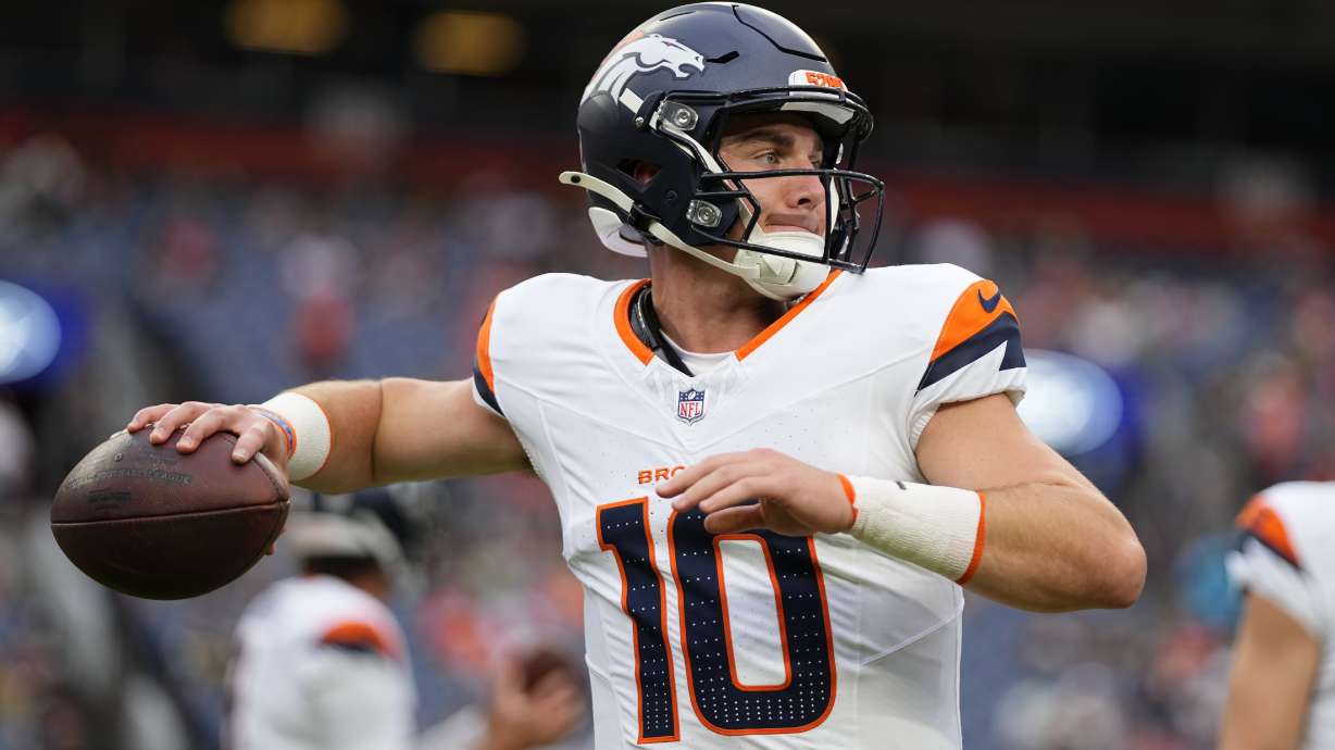Denver Broncos quarterback Bo Nix warms up before a preseason NFL football game against the Green Bay Packers, Sunday, Aug. 18, 2024, in Denver.