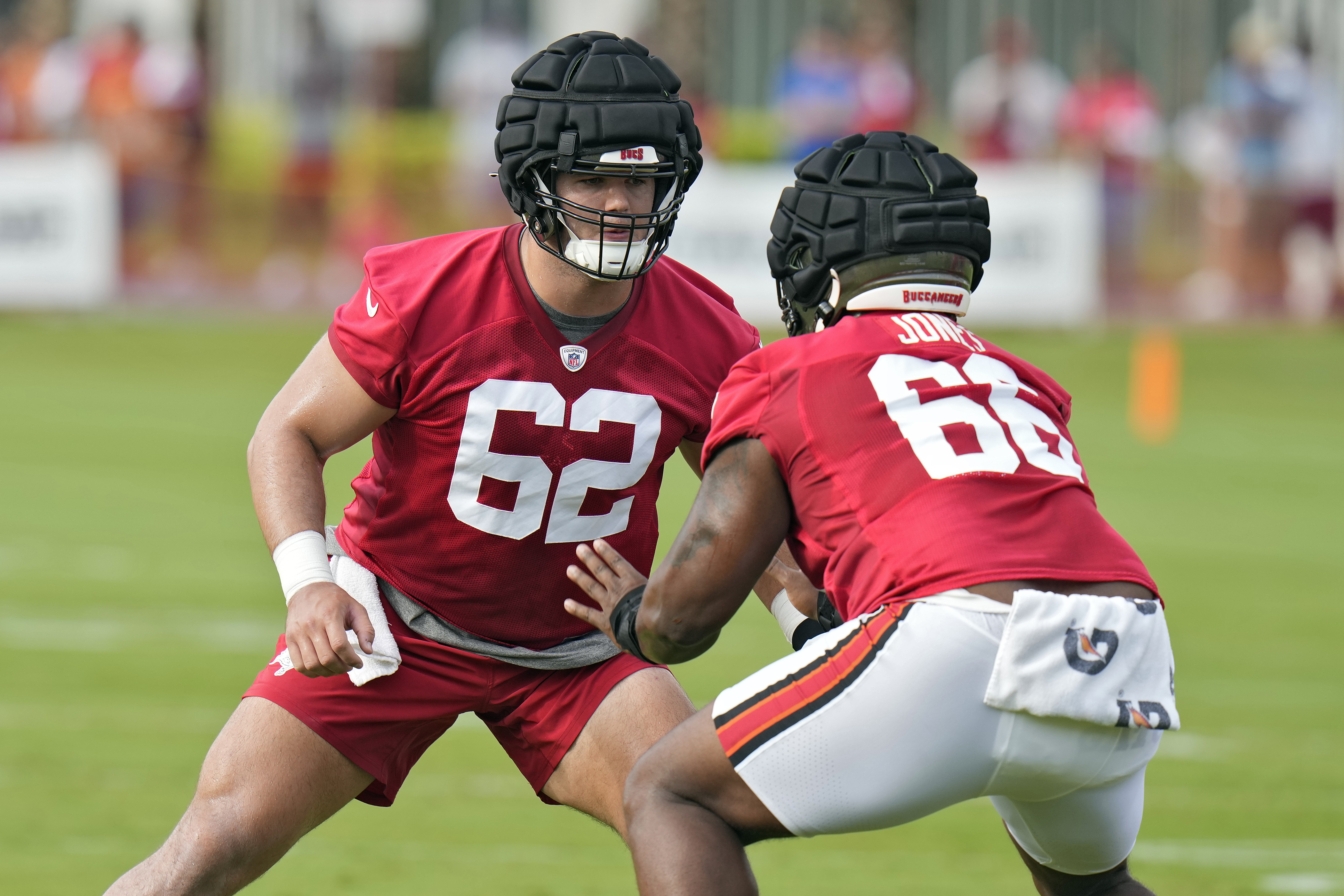 Tampa Bay Buccaneers 2024 first-round draft pick Graham Barton (62) works against guard Avery Jones during an NFL football training camp practice Thursday, July 25, 2024, in Tampa, Fla. 