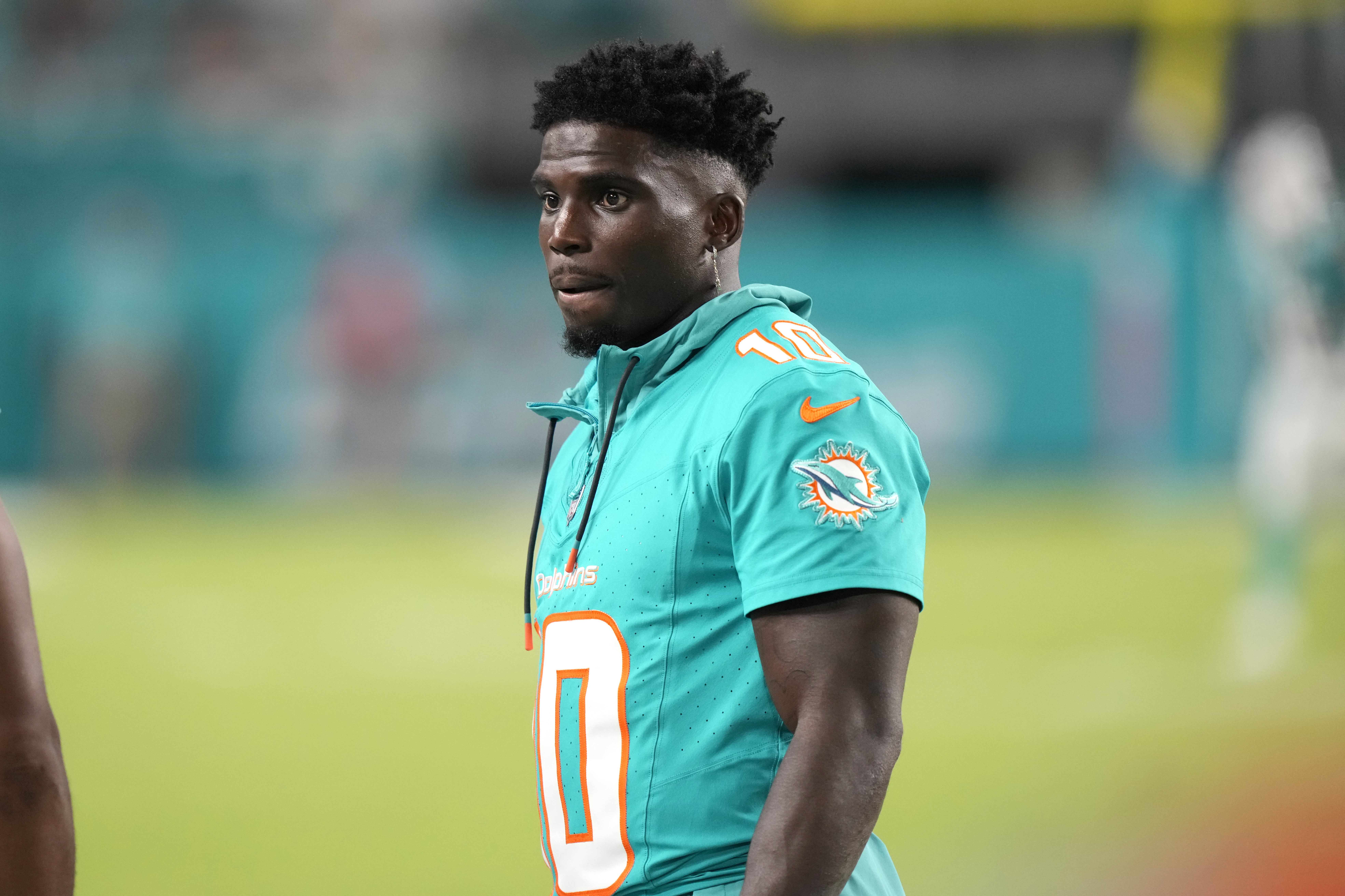 Miami Dolphins wide receiver Tyreek Hill watches from the sideline during the second half of a preseason NFL football game against the Washington Commanders, Saturday, Aug. 17, 2024, in Miami Gardens, Fla. 