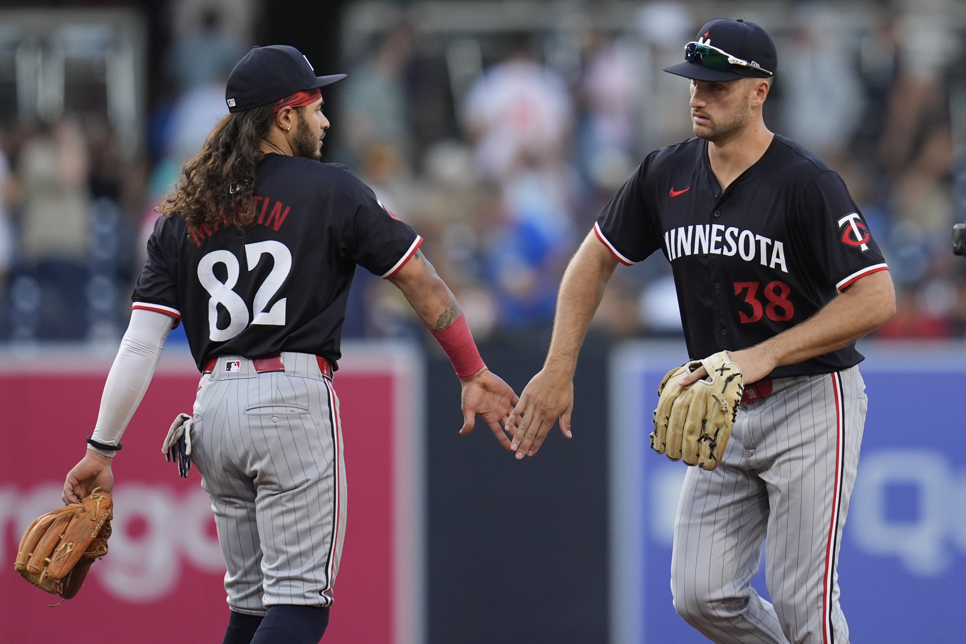 Minnesota Twins right fielder Matt Wallner, right, celebrates with teammate center fielder Austin Martin after the Twins defeated the San Diego Padres 11-4 in a baseball game Wednesday, Aug. 21, 2024, in San Diego.