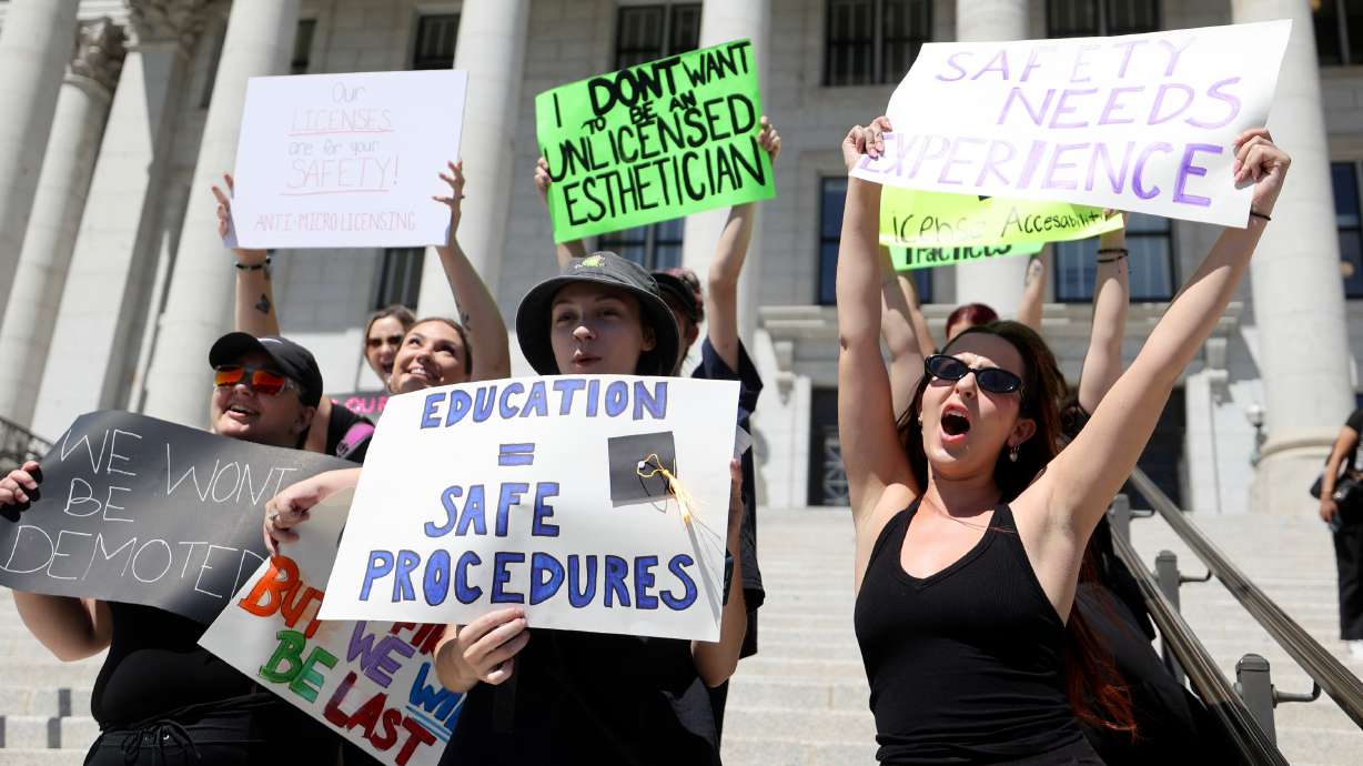 In the front from left to right, McKenna Roberts, Katelyn Kapinos and Navie Oleska hold signs and wear all black to protest changing cosmetology licensing during a special Utah legislative session outside of the Capitol in Salt Lake City on Wednesday.
