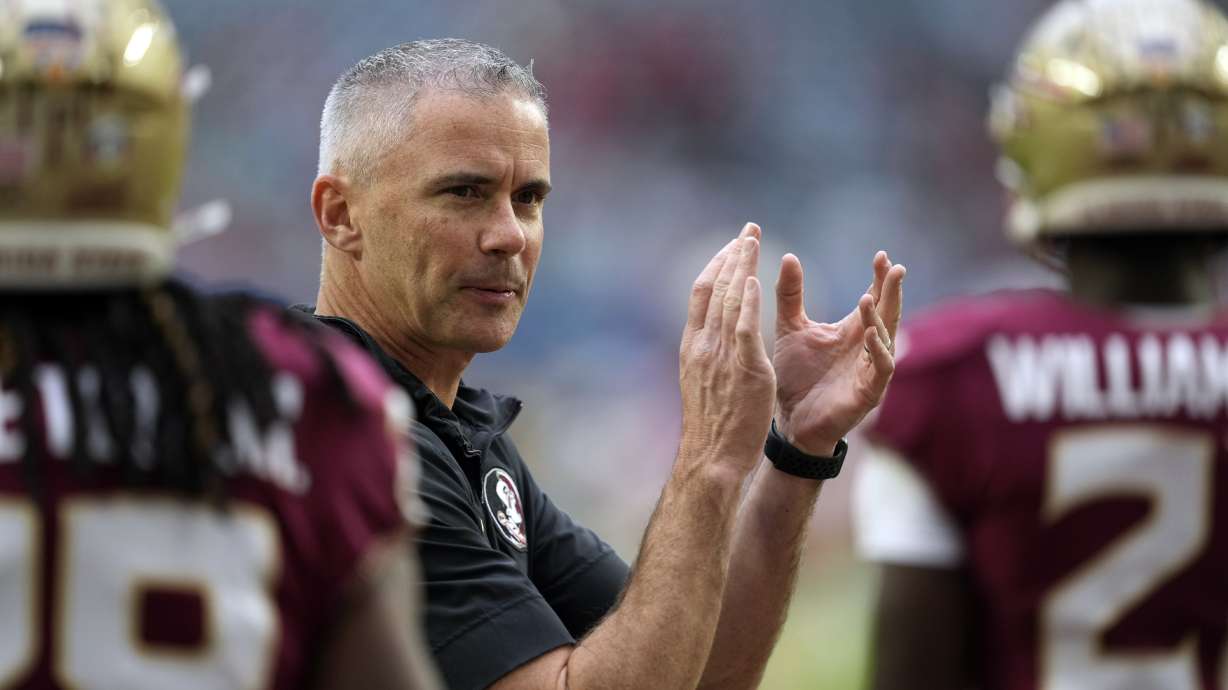 FILE - Florida State head coach Mike Norvell claps as his players warm up for the Orange Bowl NCAA college football game against Georgia, Saturday, Dec. 30, 2023, in Miami Gardens, Fla.