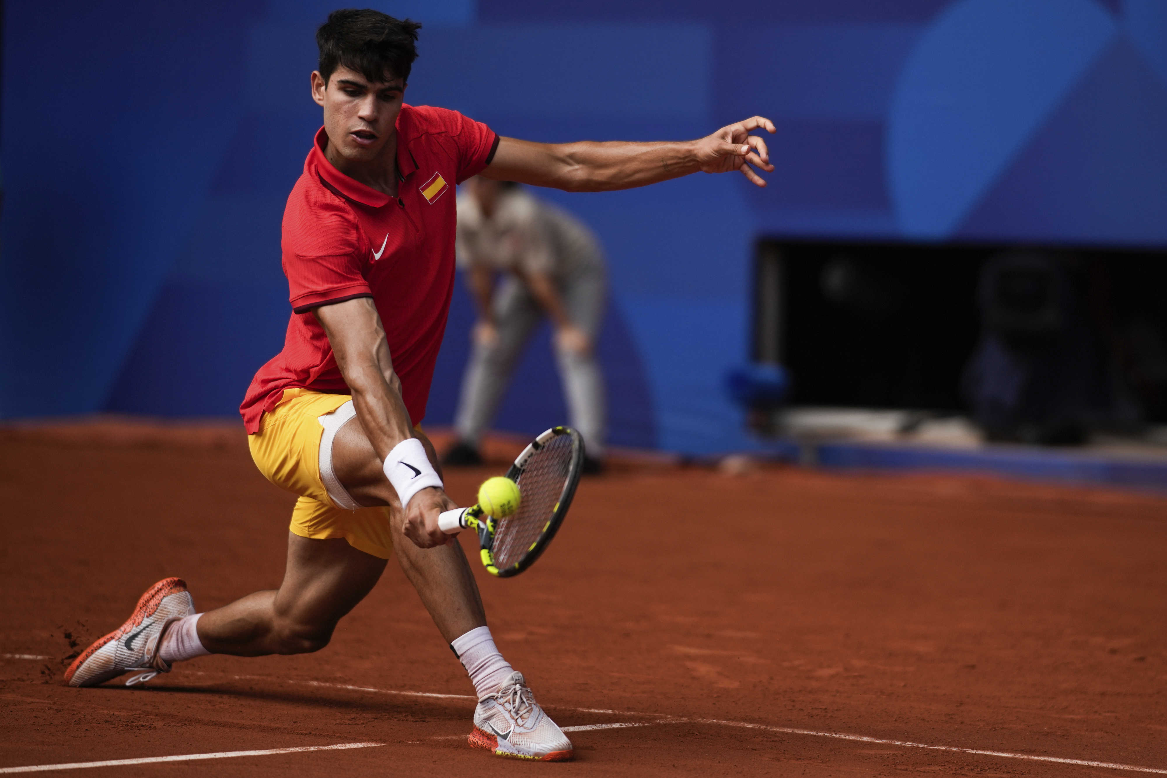 Spain's Carlos Alcaraz backhands to Serbia's Novak Djokovic during the men's singles tennis final at the Roland Garros stadium during the 2024 Summer Olympics, Sunday, Aug. 4, 2024, in Paris, France. 