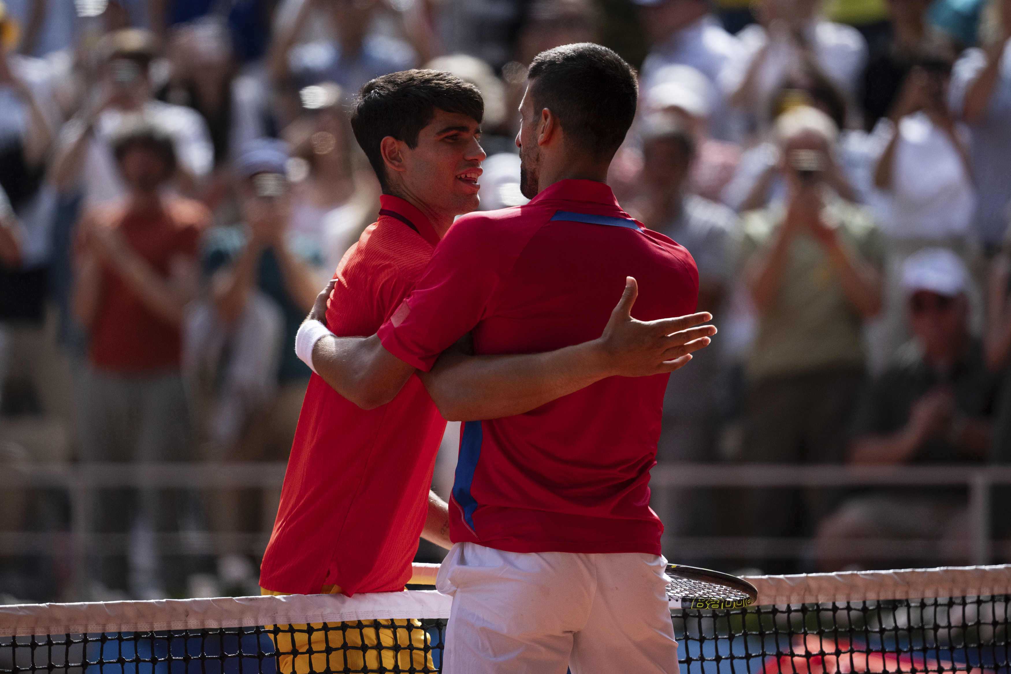 Serbia's Novak Djokovic and Spain's Carlos Alcaraz great each other after the men's singles tennis final at the Roland Garros stadium during the 2024 Summer Olympics, Sunday, Aug. 4, 2024, in Paris, France.