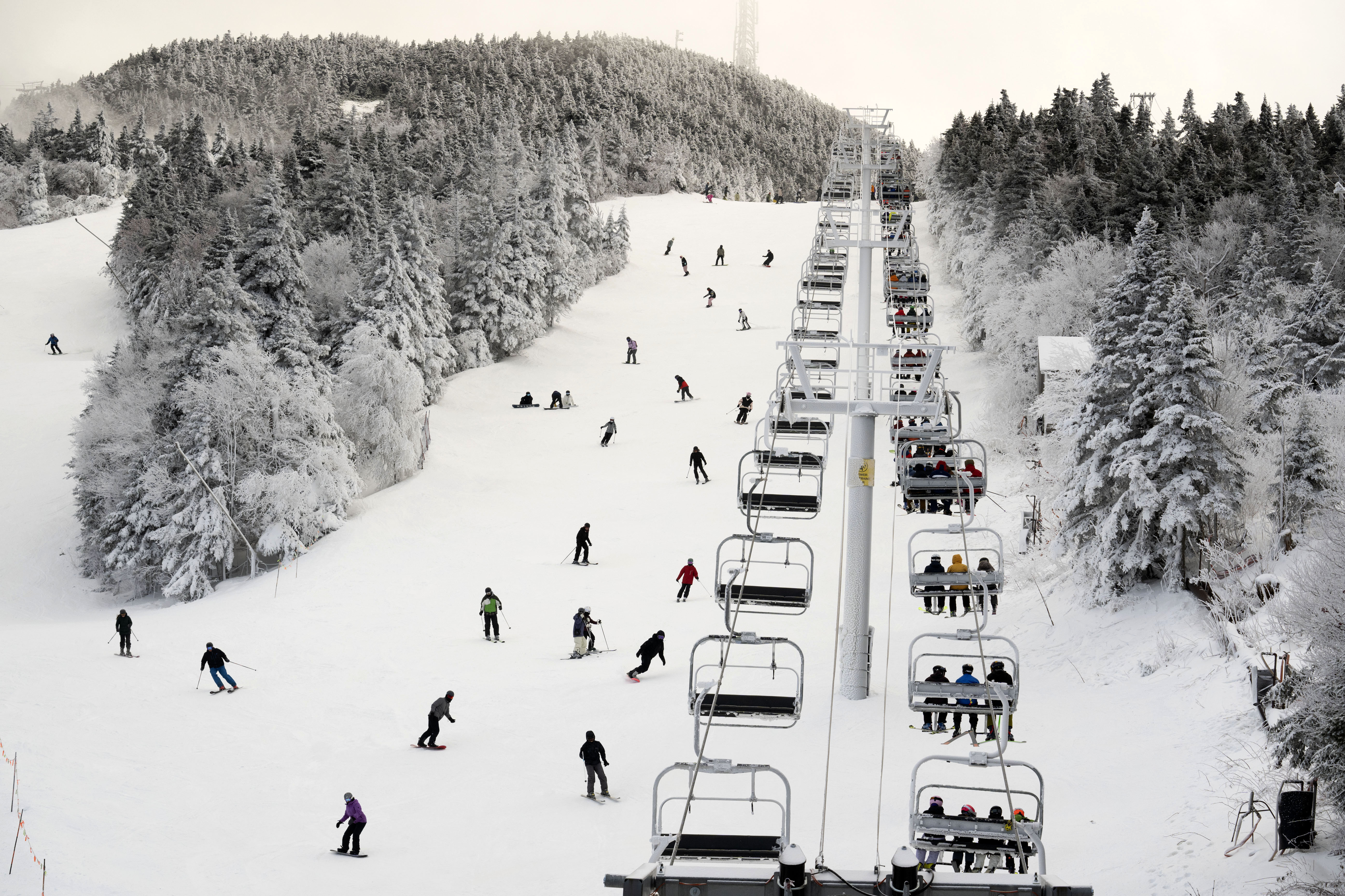 FILE - Thanksgiving holiday skiers descend near the North Ridge Quad chairlift, Nov. 24, 2023, at Killington Ski Resort in Killington, Vt. 
