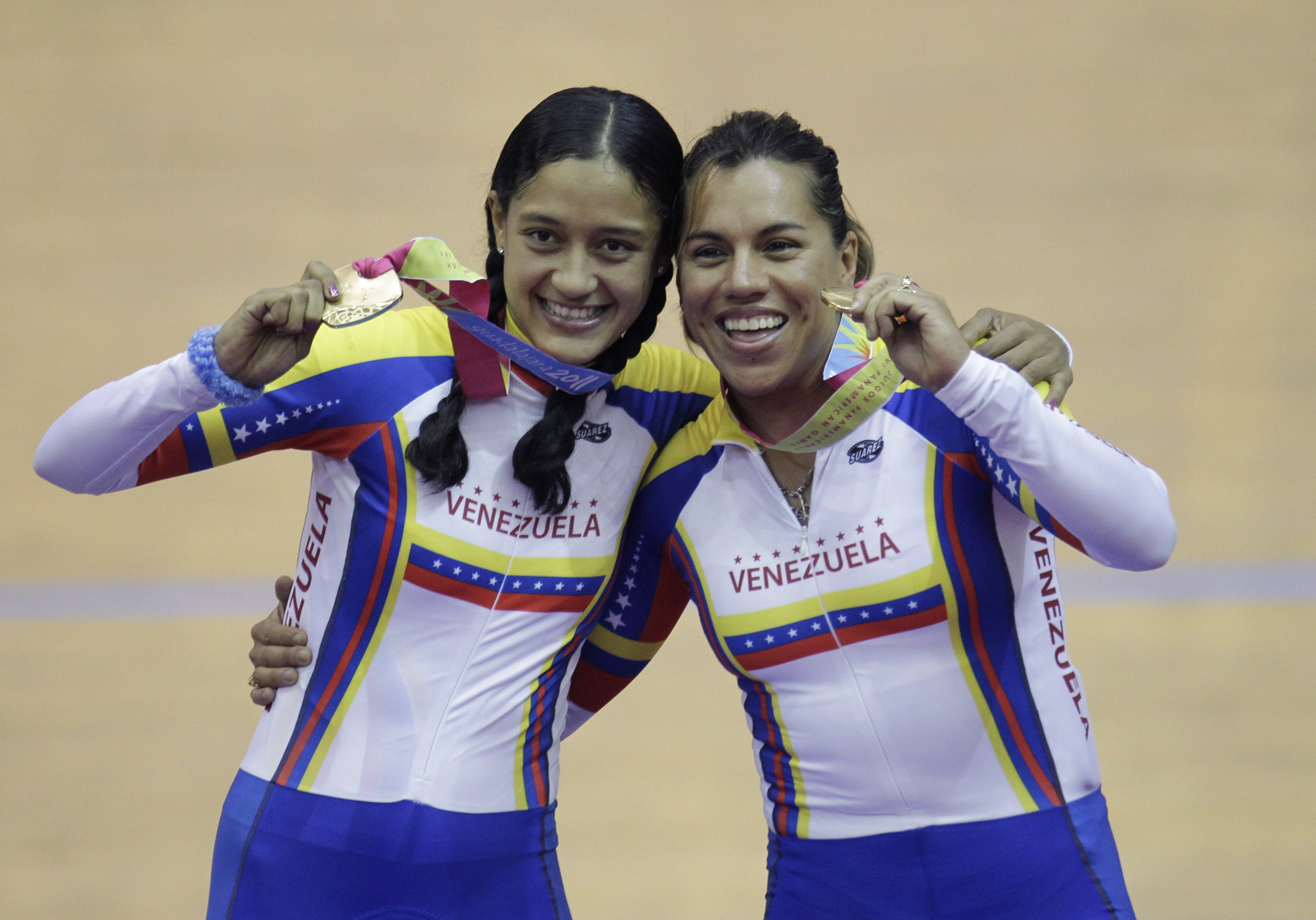 FILE - Venezuela's Mariestela Vilera, left, and Daniela Larreal celebrate after won gold medal in a cycling women's team pursuit final at Pan American Games in Guadalajara, Mexico, Monday, Oct. 17, 2011.