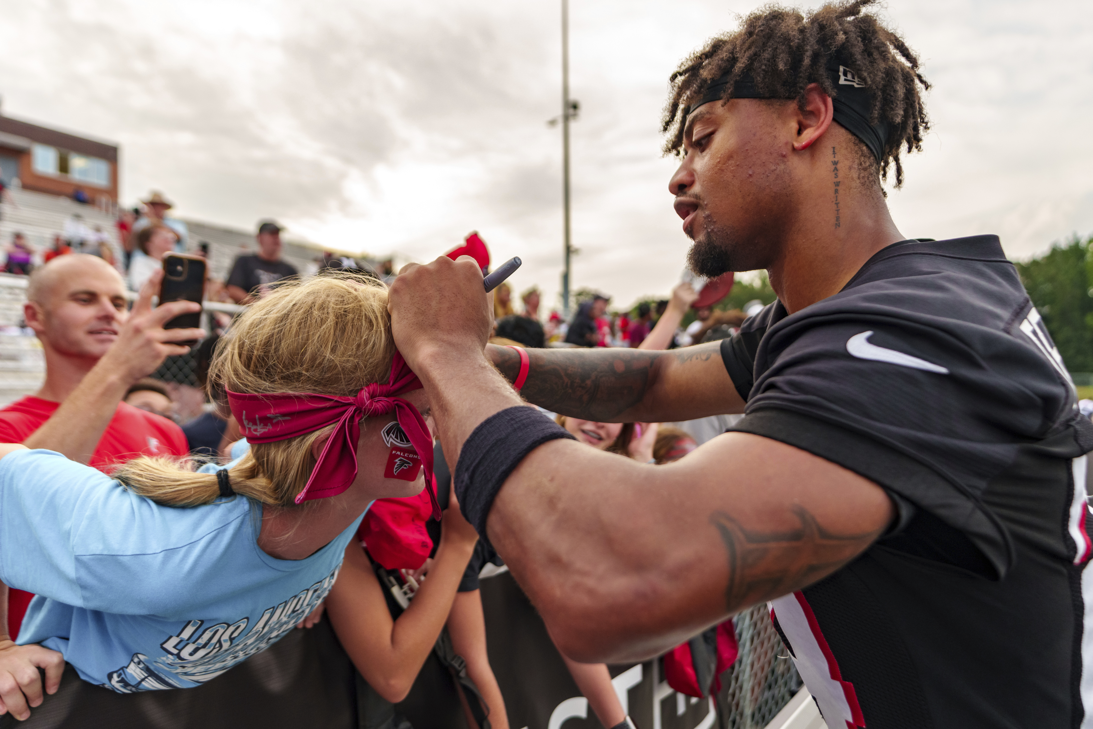 Atlanta Falcons cornerback A.J. Terrell (24) signs autographs during an NFL training camp football practice, Saturday, July 27, 2024, in Buford, Ga. 