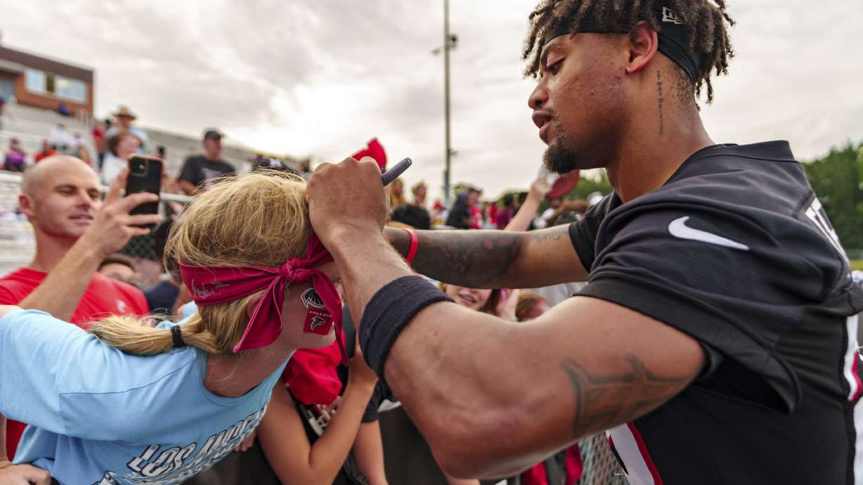 Atlanta Falcons cornerback A.J. Terrell (24) signs autographs during an NFL training camp football practice, Saturday, July 27, 2024, in Buford, Ga.