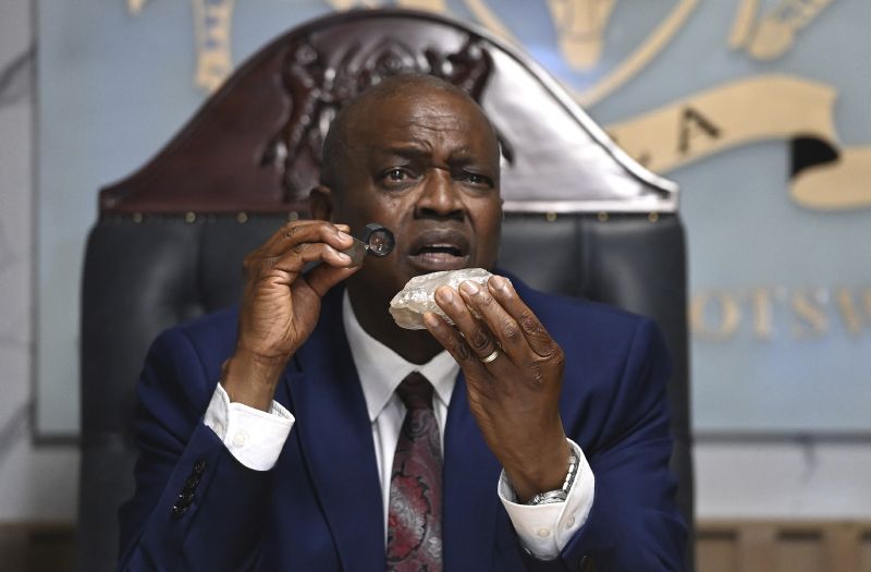 Botswana's President Mokgweetsi Masisi holds the 2,492-carat diamond unearthed at one of its mines and will be put on show, Thursday in Gaborone, Botswana.