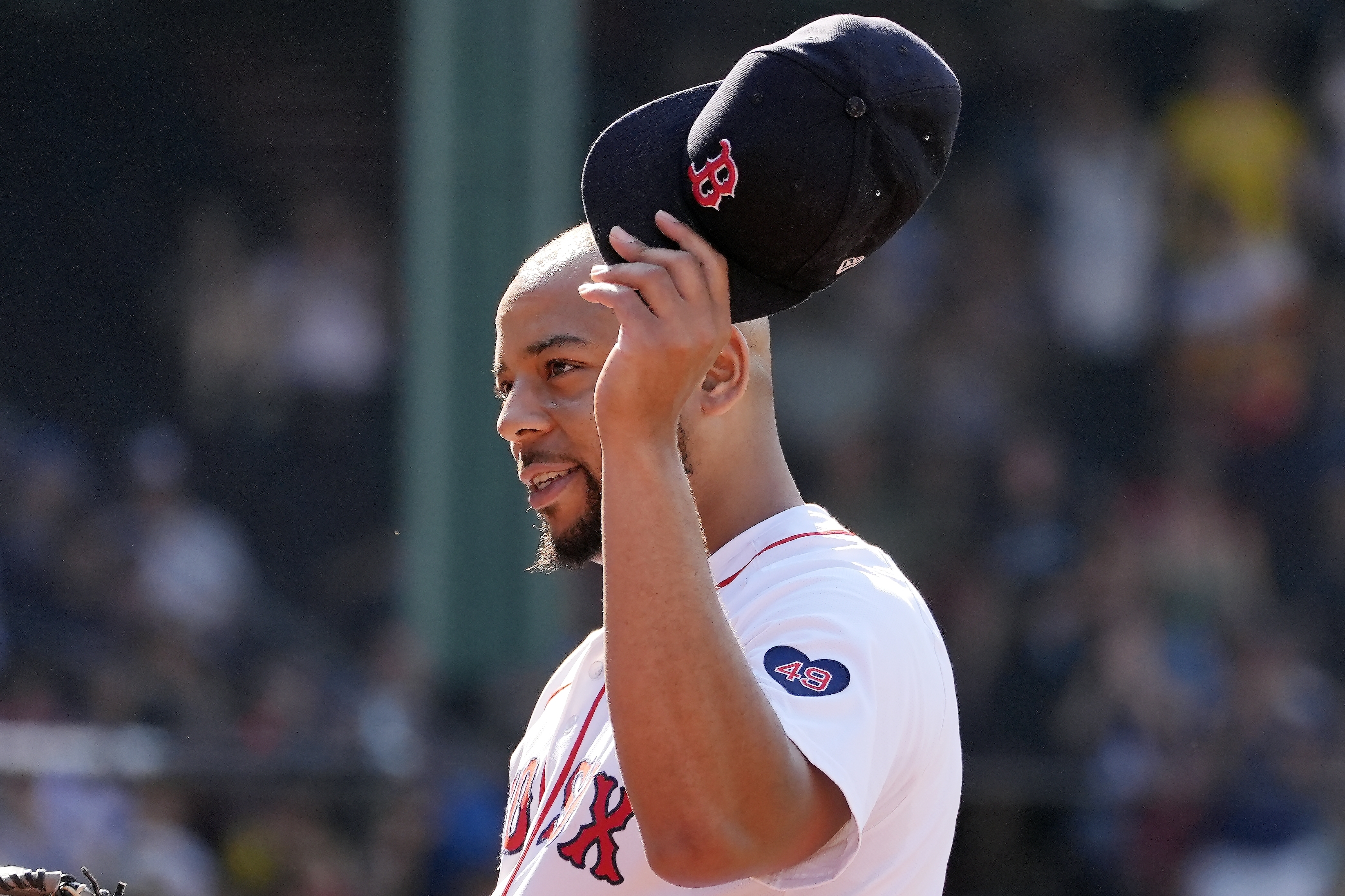 Boston Red Sox first baseman Dominic Smith tips his cap after pitching during the ninth inning of a baseball game against the Houston Astros, Sunday, Aug. 11, 2024, in Boston. 