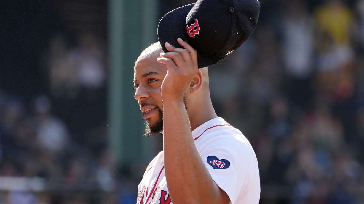 Boston Red Sox first baseman Dominic Smith tips his cap after pitching during the ninth inning of a baseball game against the Houston Astros, Sunday, Aug. 11, 2024, in Boston.