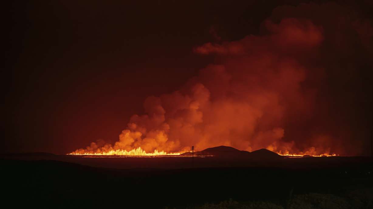 A new volcanic eruption is seen from the intersection between Reykjanesbraut, Iceland, and the road to Grindavik, Thursday.